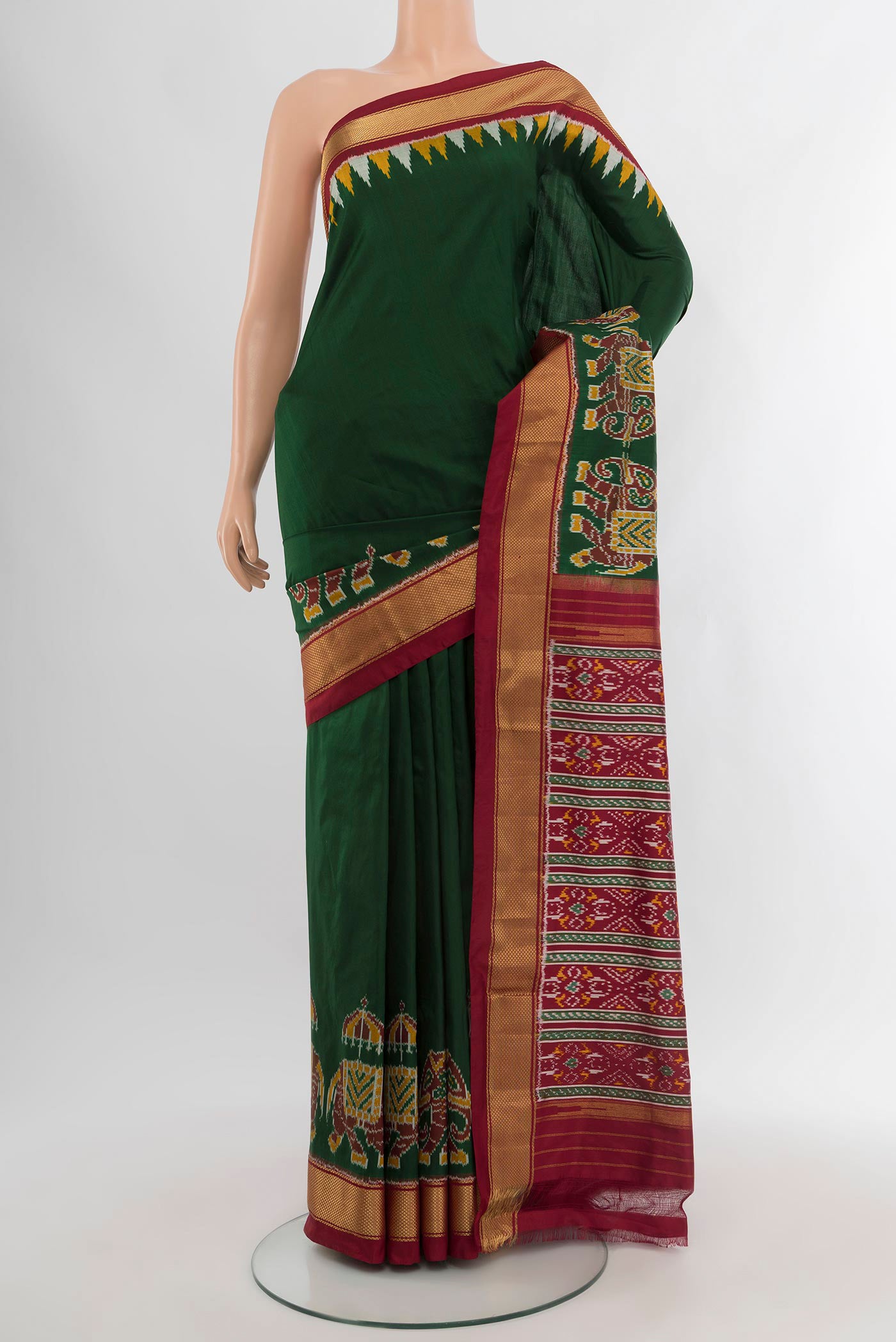 Bottle Green Pochampally Silk Saree with Plain Body and Zari Border.  displayed on a mannequin