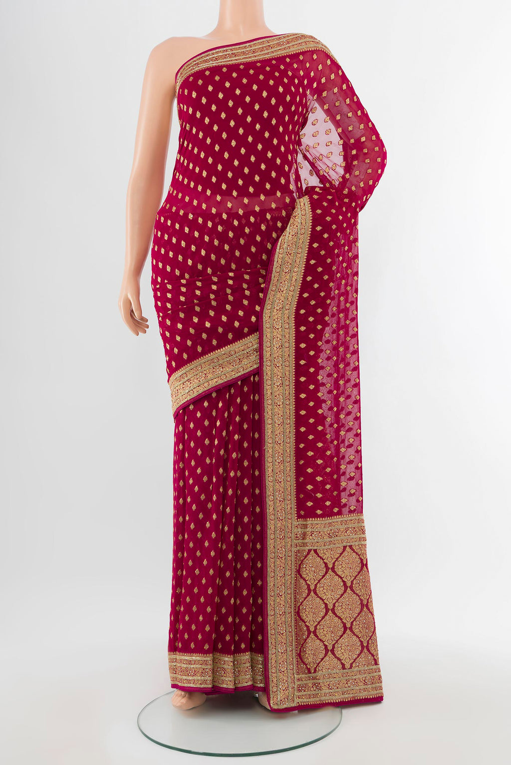 Maroon Embroidery Net Saree with Zari Butta on the body and Silk Border.  displayed on a mannequin
