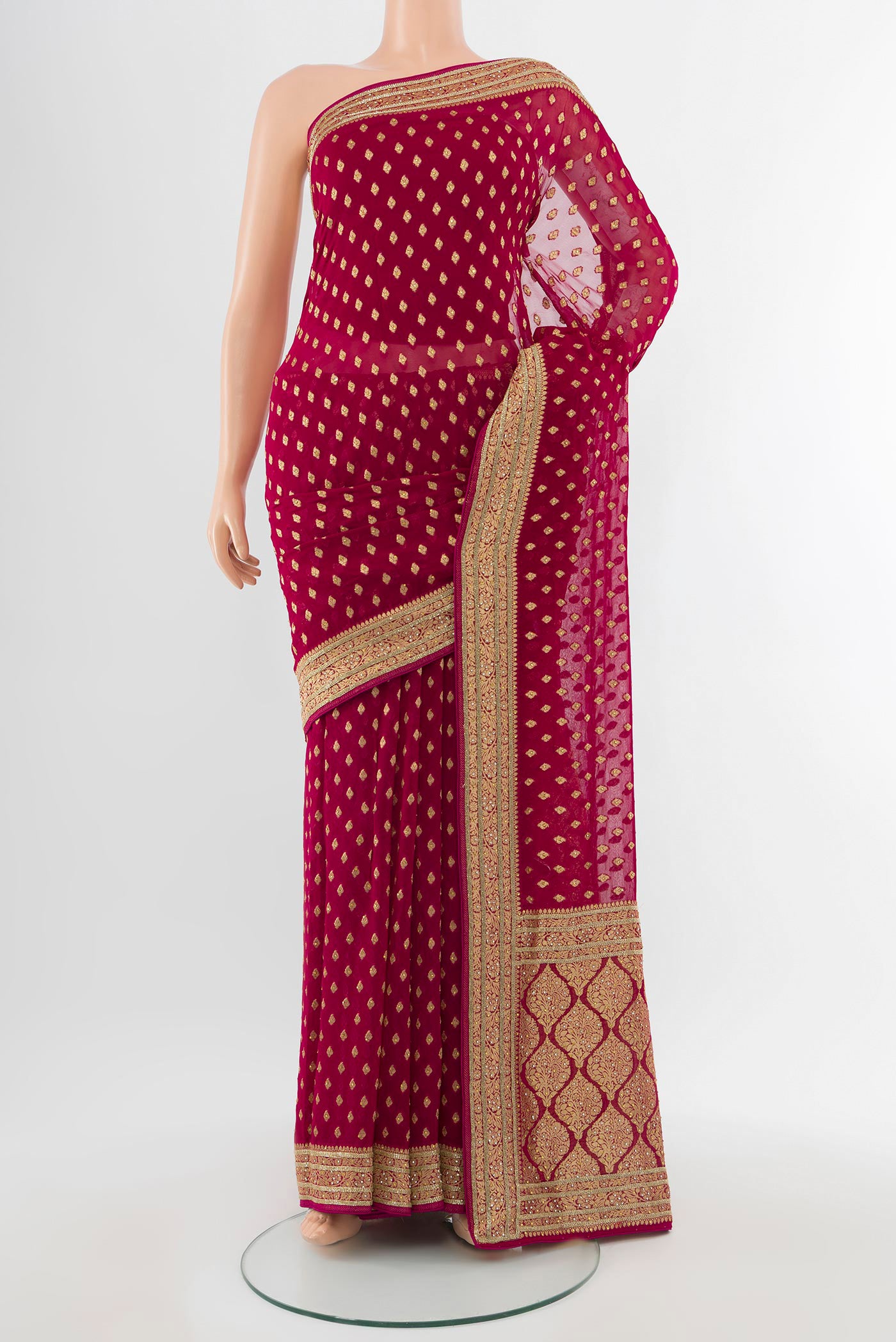 Maroon Embroidery Net Saree with Zari Butta on the body and Silk Border.  displayed on a mannequin
