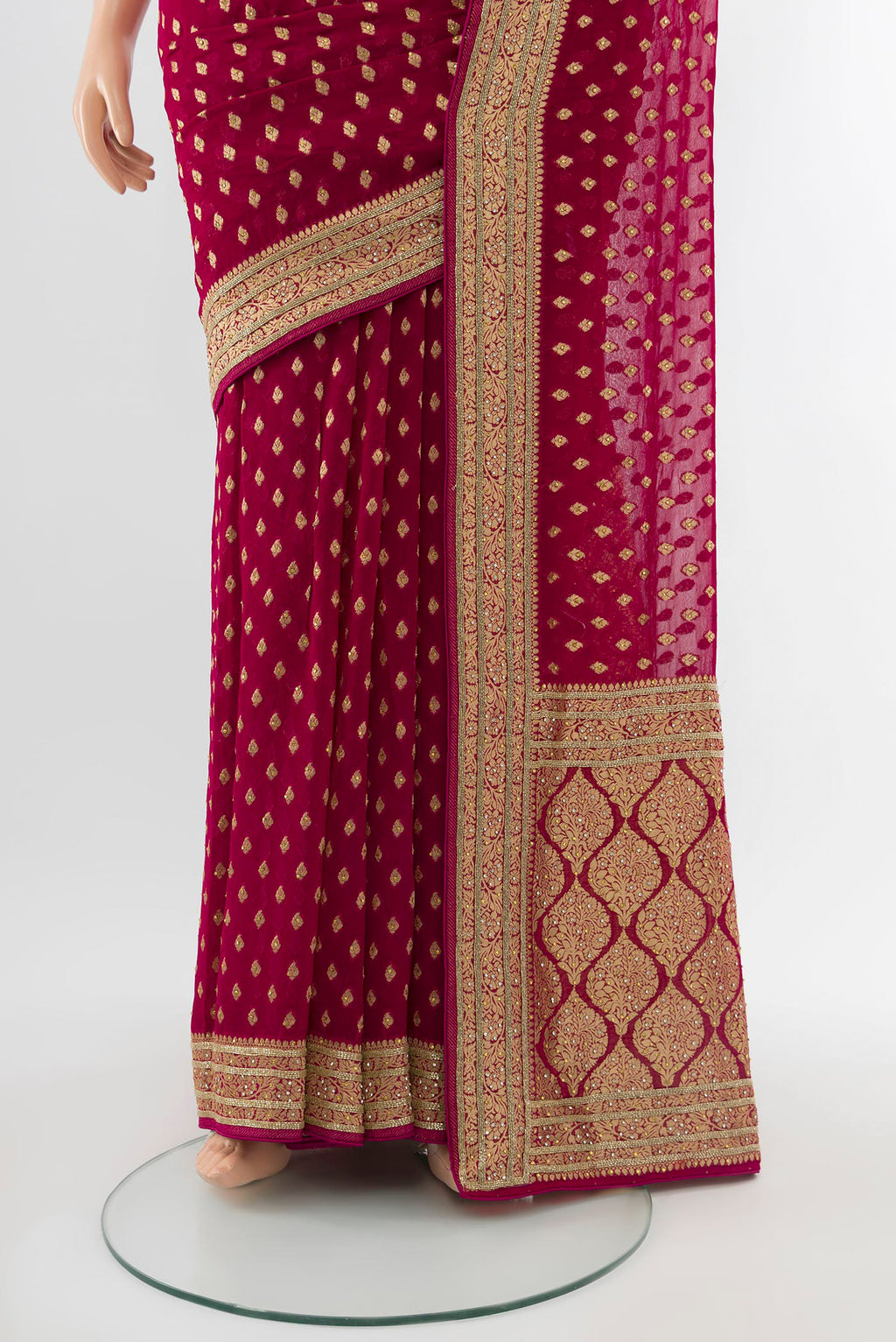 Pleats and pallu of Maroon Embroidery Net Saree with Zari Butta on the body and Silk Border. 
