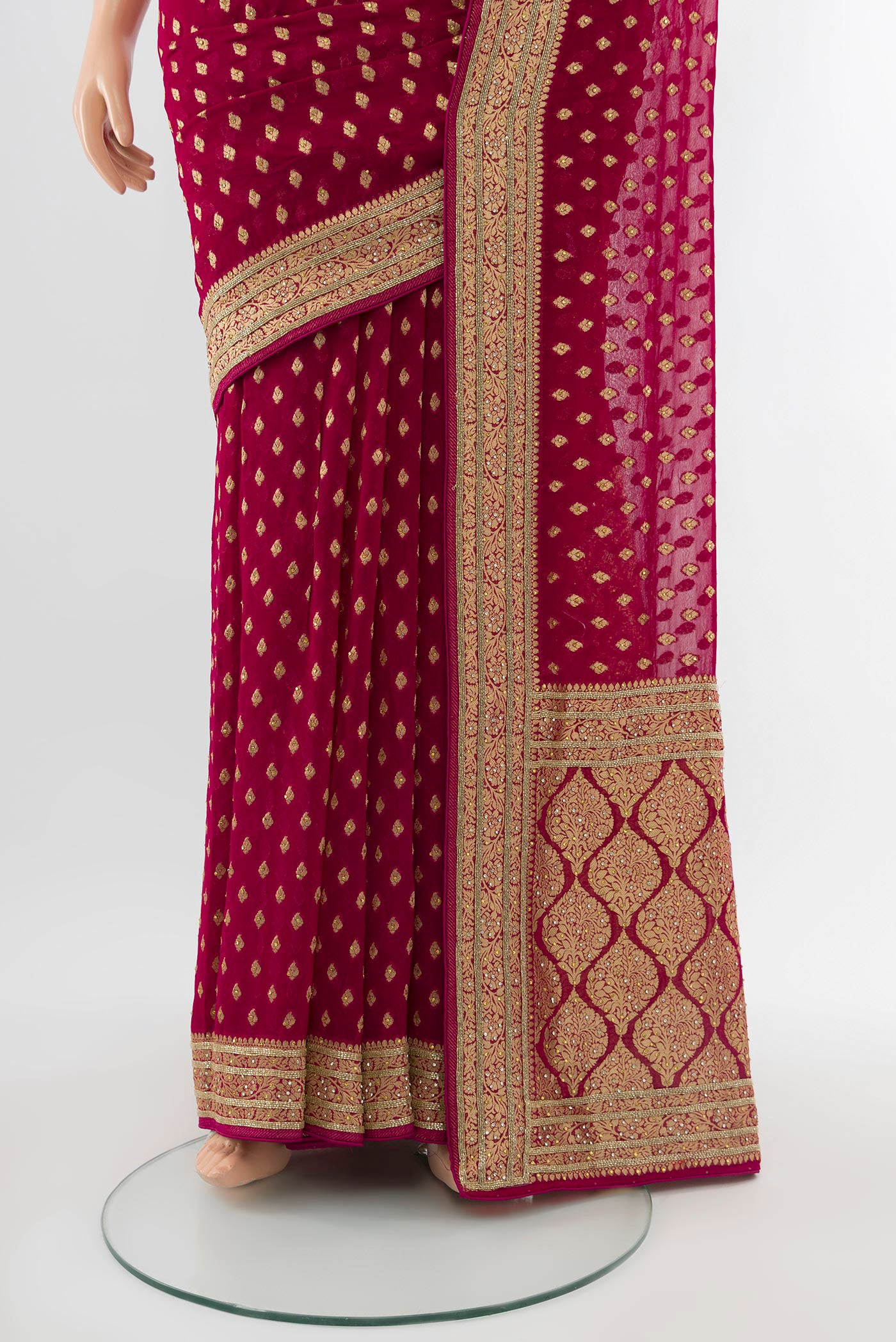 Pleats and pallu of Maroon Embroidery Net Saree with Zari Butta on the body and Silk Border. 