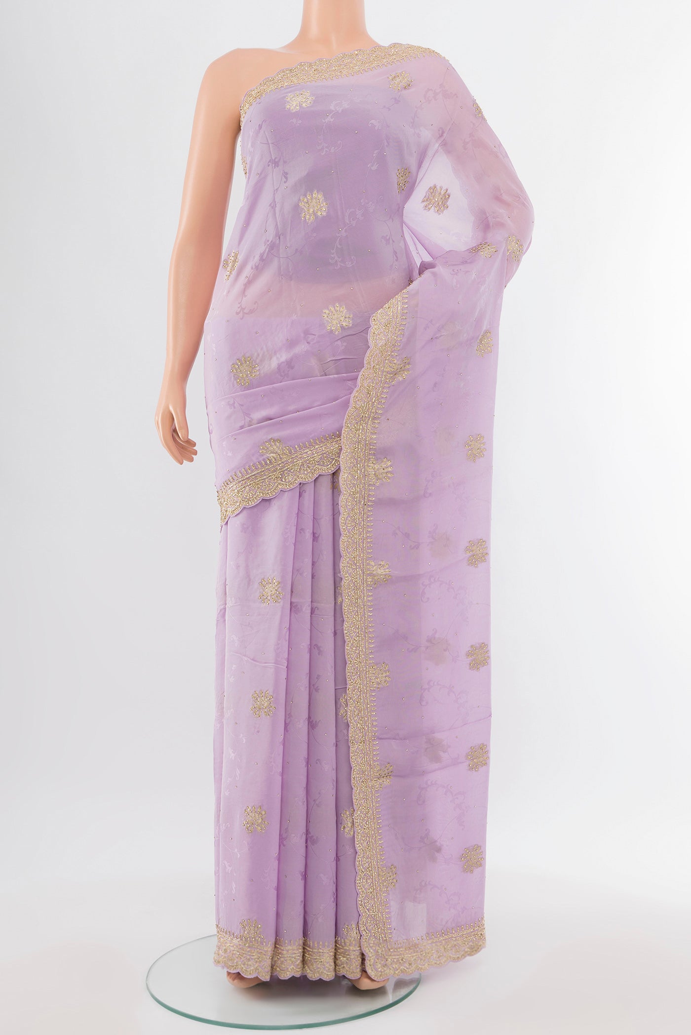 Violet Embroidery Net Saree with Embroidery on the body and Silk Border.  displayed on a mannequin