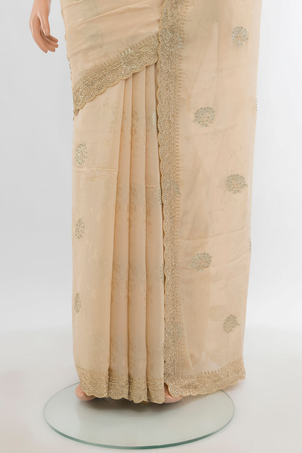 Pleats and pallu of Cream Blended Art Silk Saree with Embroidery on the body and Fancy Border. 