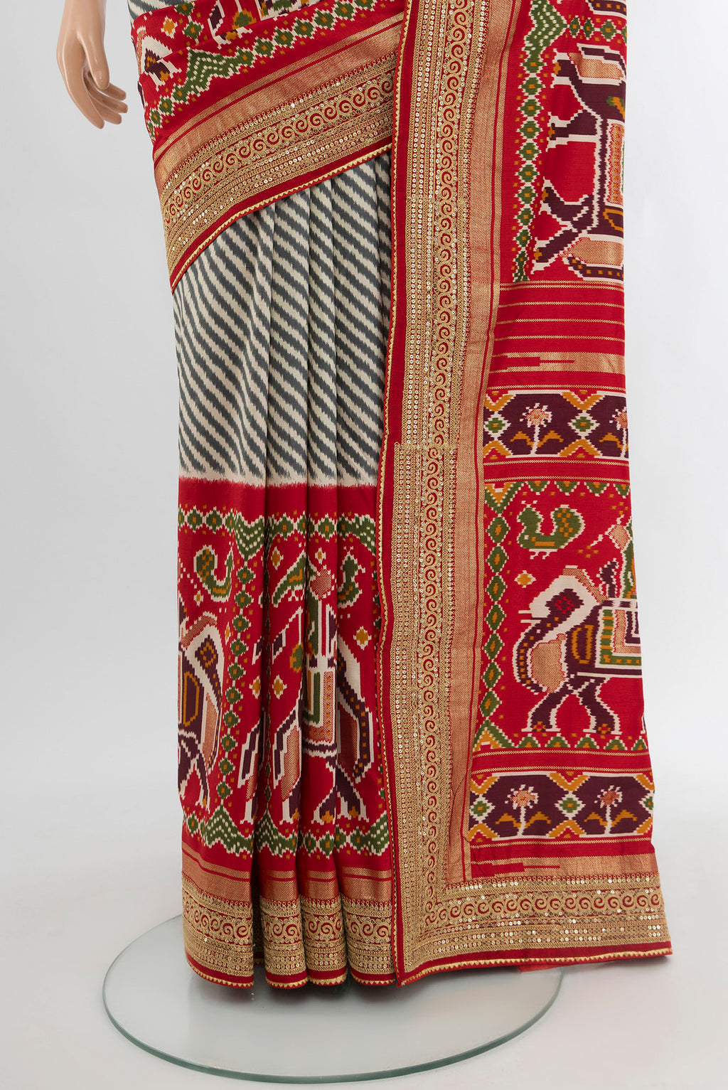 Pleats and pallu of Off White Art Silk Saree with Embroidery on the body and Zari Border. 