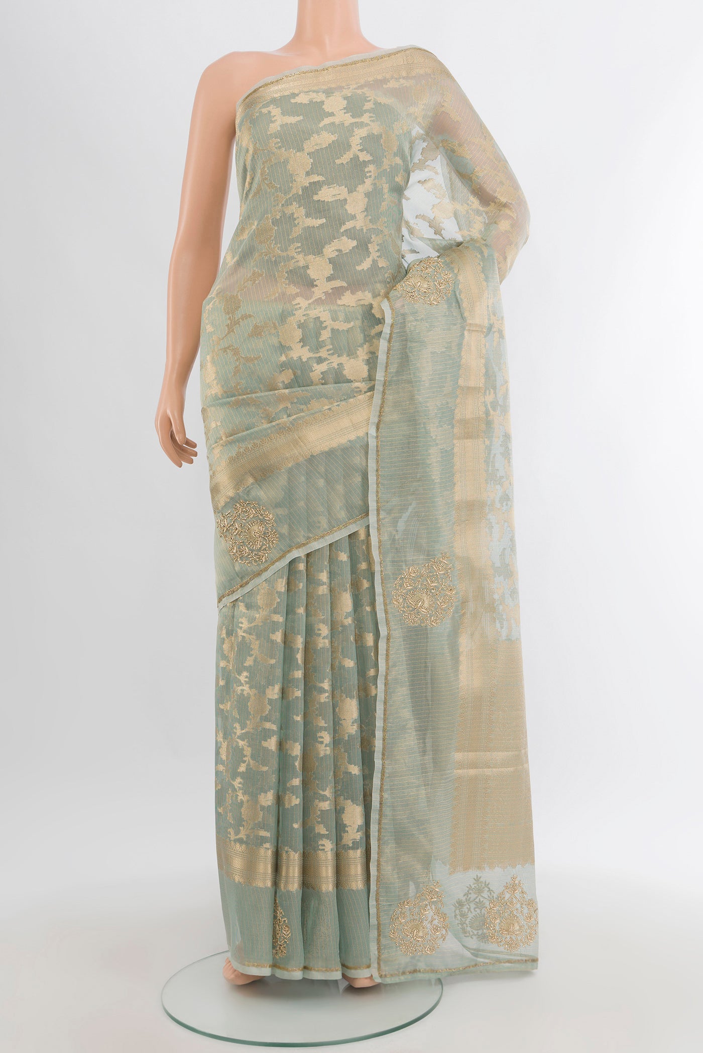 Light Green Embroidery Net Saree with Embroidery on the body and Fancy Border.  displayed on a mannequin