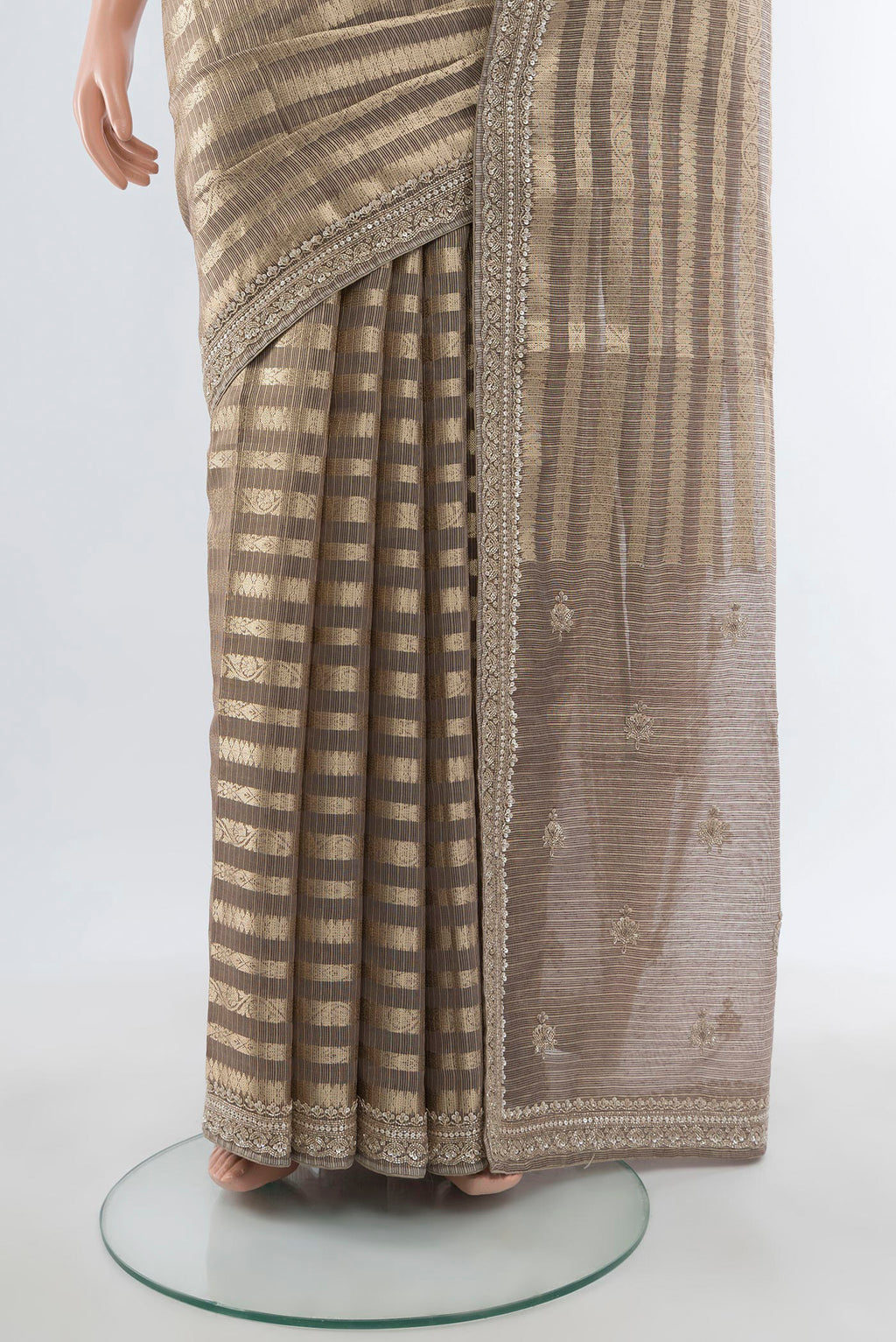 Pleats and pallu of Golden Art Silk Saree with Stripes on the body and Embroidery Border. 