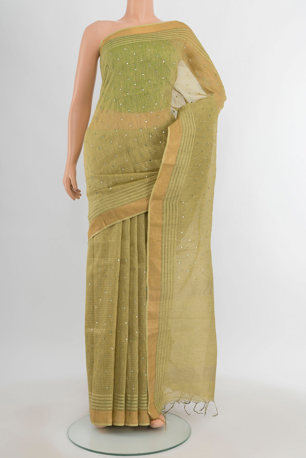 Light Green Tussar Silk Saree with Embroidery on the body and Silk Border.  displayed on a mannequin