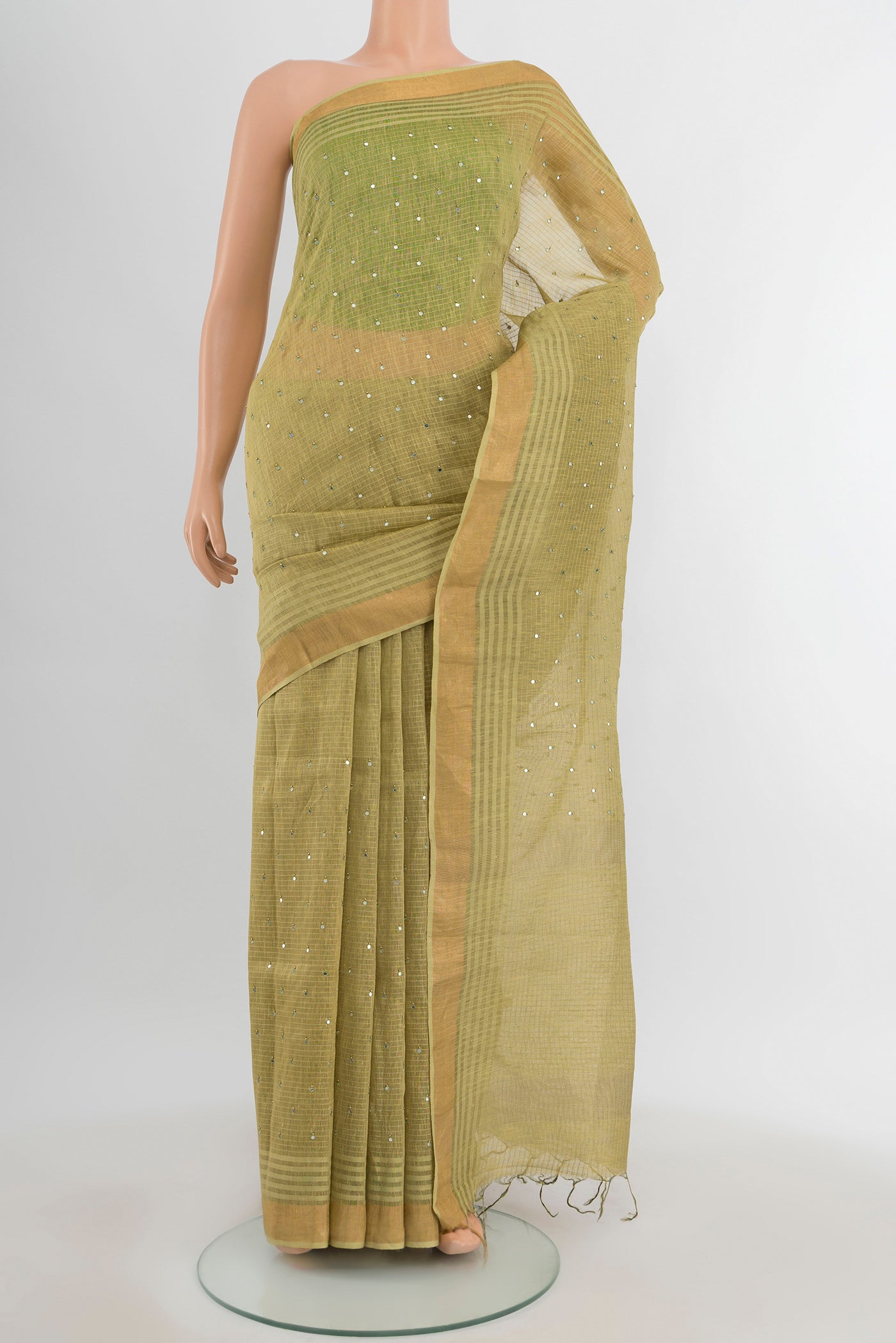Light Green Tussar Silk Saree with Embroidery on the body and Silk Border.  displayed on a mannequin