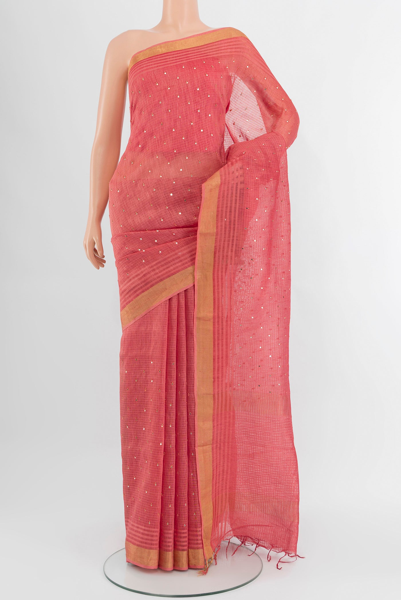 Pink Tussar Silk Saree with Embroidery on the body and Zari Border.  displayed on a mannequin