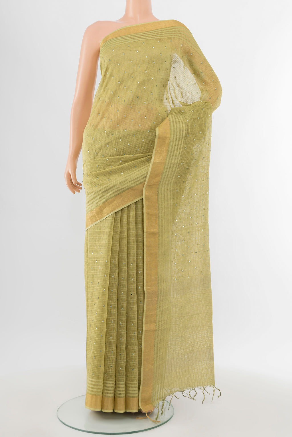 Light Green Tussar Silk Saree with Embroidery on the body and Silk Border.  displayed on a mannequin