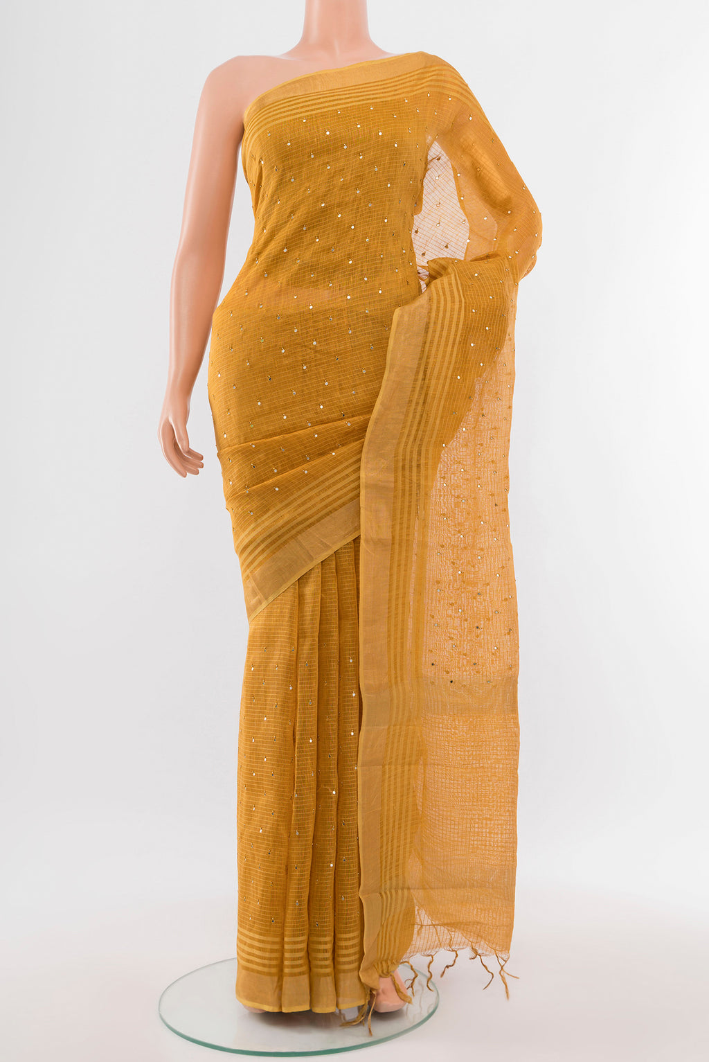 Mustard Tussar Silk Saree with Embroidery on the body and Silk Border.  displayed on a mannequin