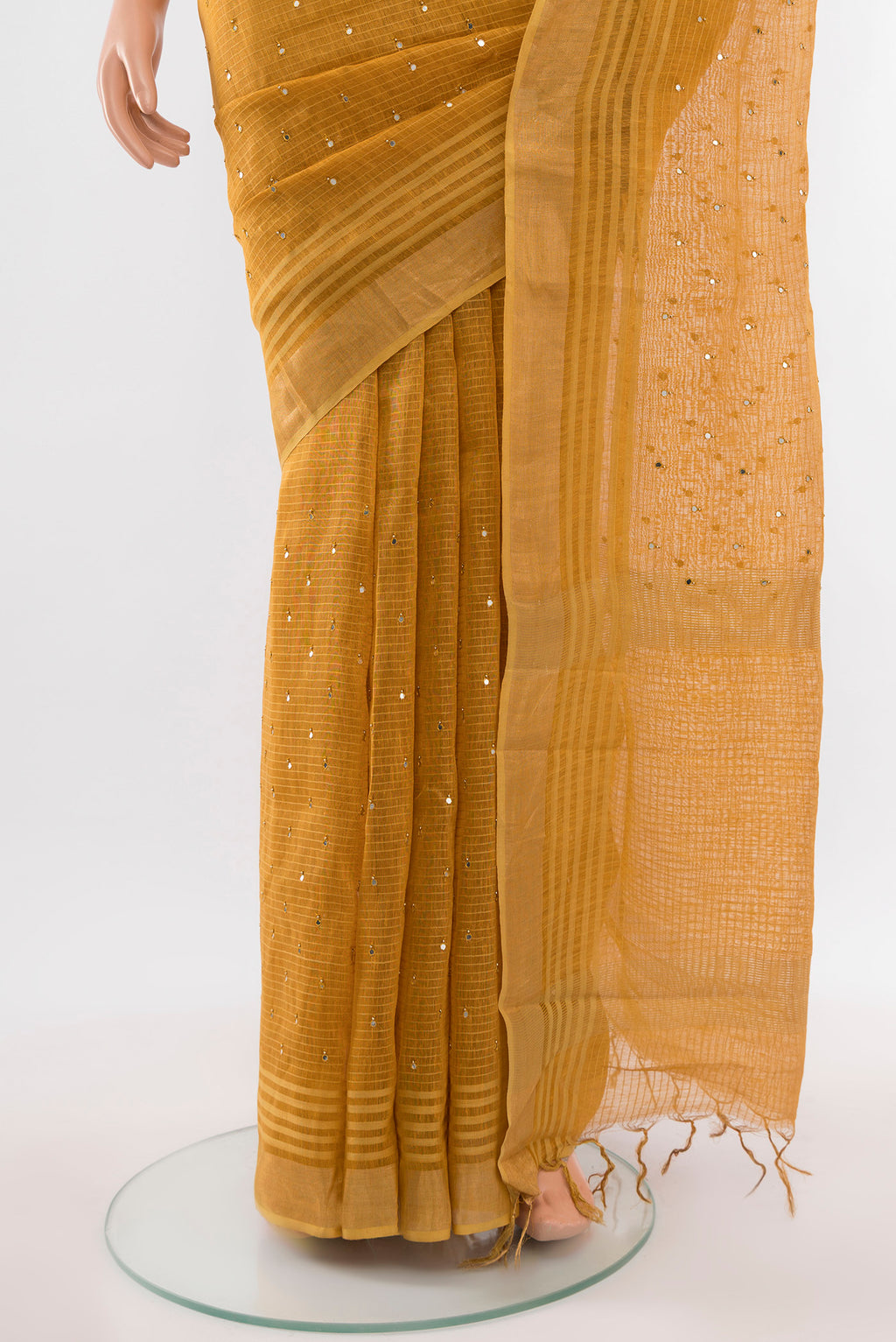 Pleats and pallu of Mustard Tussar Silk Saree with Embroidery on the body and Silk Border. 