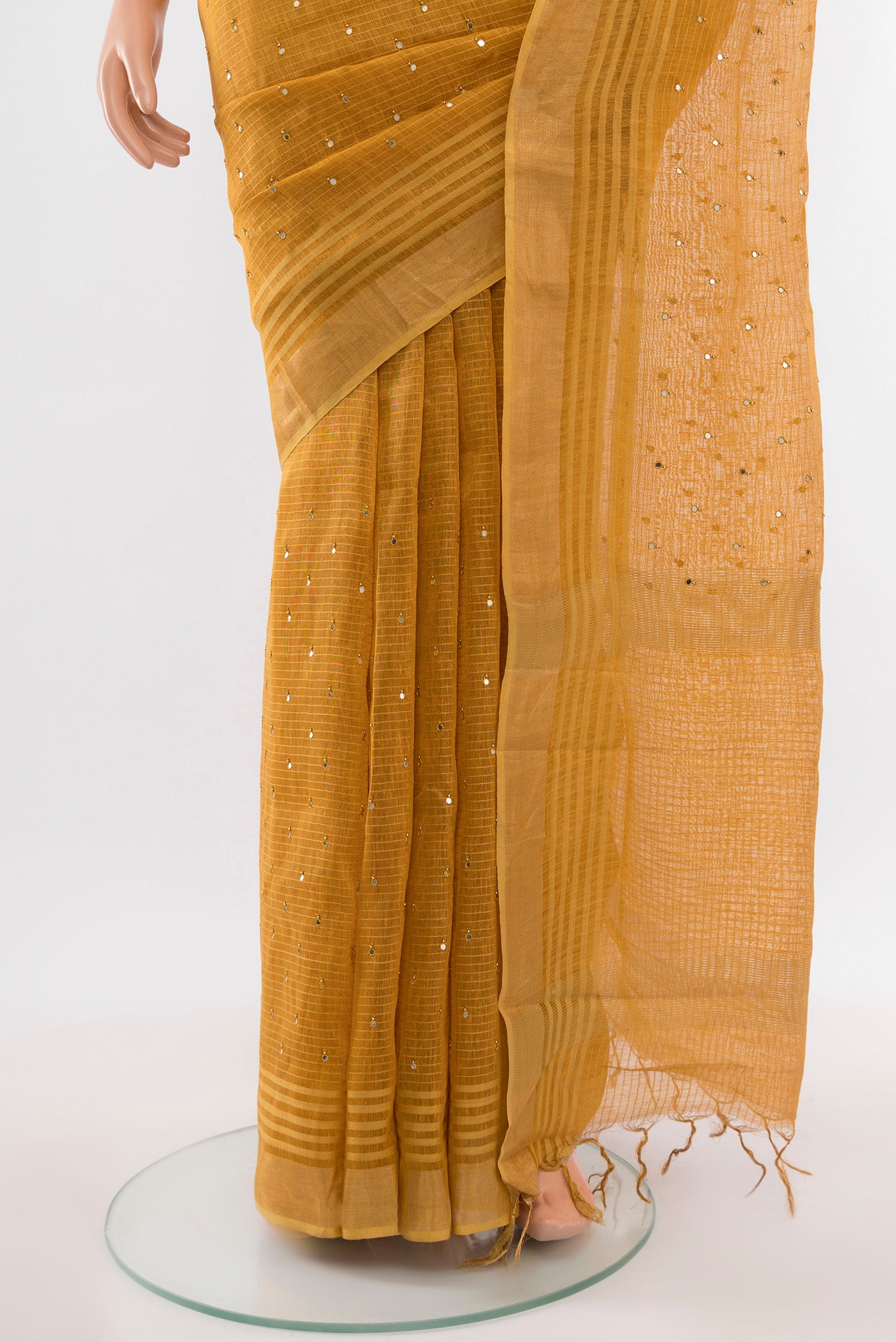 Pleats and pallu of Mustard Tussar Silk Saree with Embroidery on the body and Silk Border. 