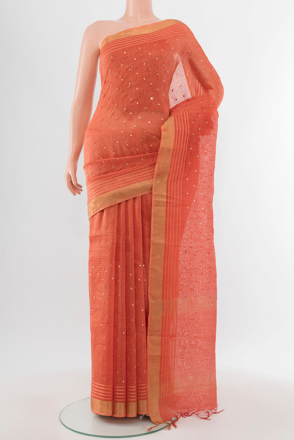 Peach Tussar Silk Saree with Embroidery on the body and Silk Border.  displayed on a mannequin
