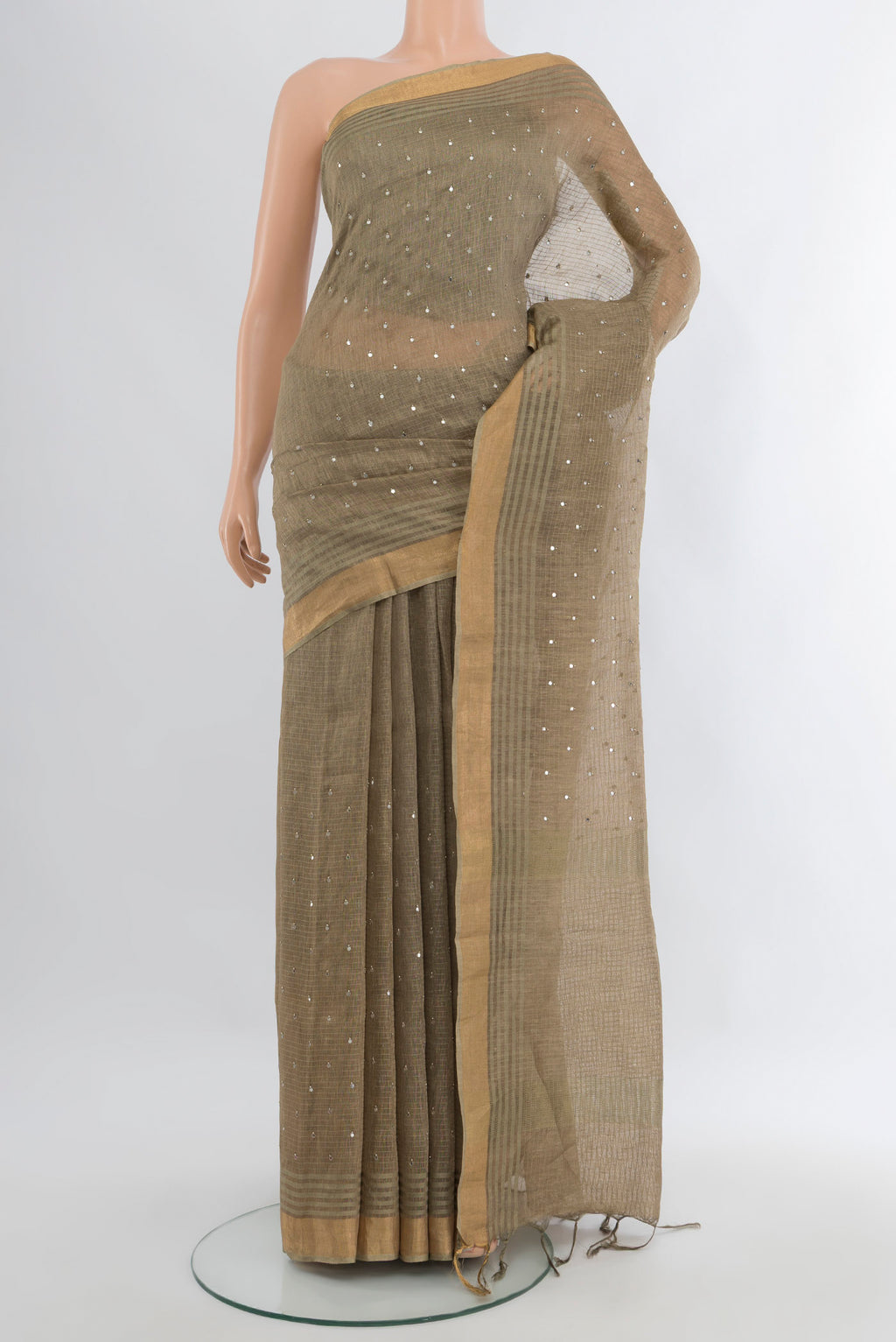 Beige Tussar Silk Saree with Embroidery on the body and Zari Border.  displayed on a mannequin