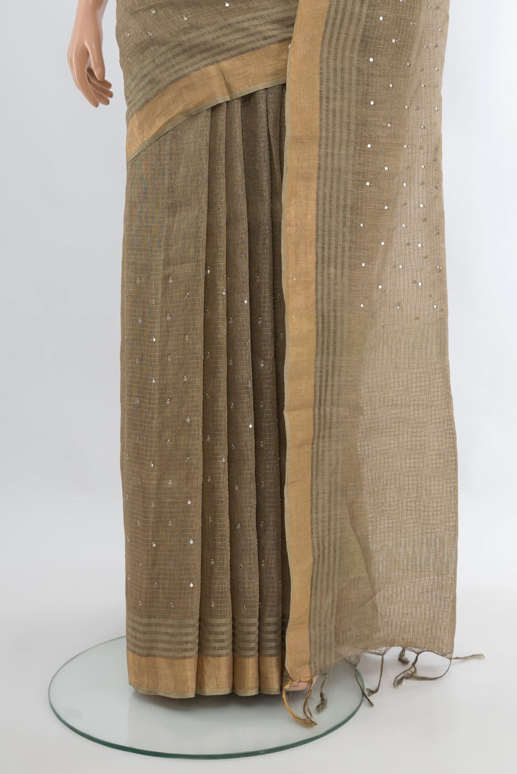 Pleats and pallu of Beige Tussar Silk Saree with Embroidery on the body and Zari Border. 