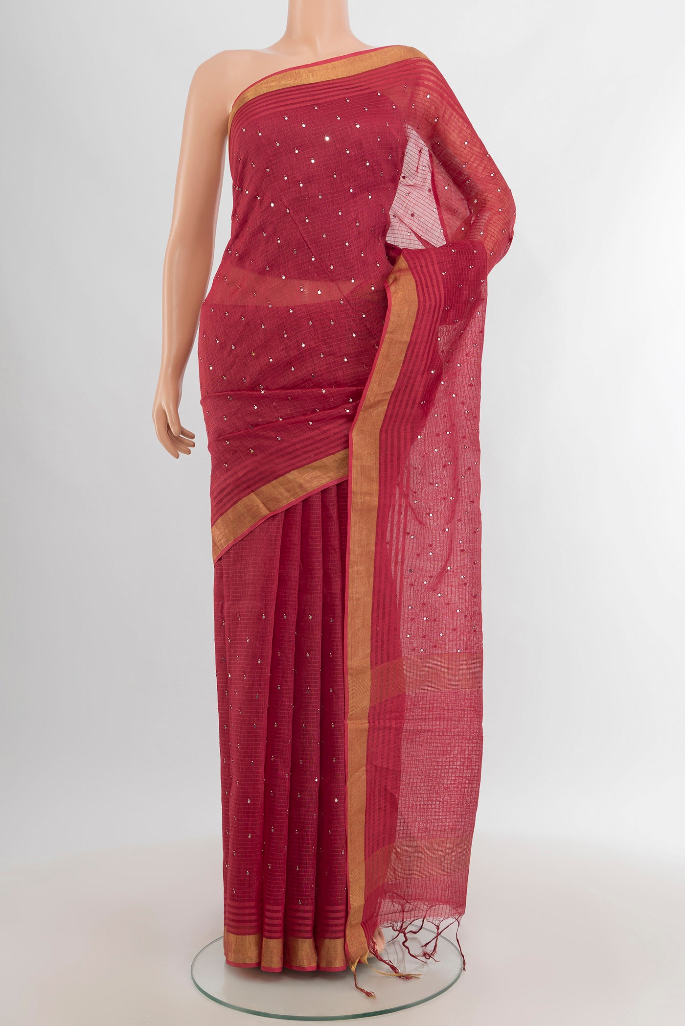 Pink Linen Saree with Embroidery on the body and Zari Border.  displayed on a mannequin