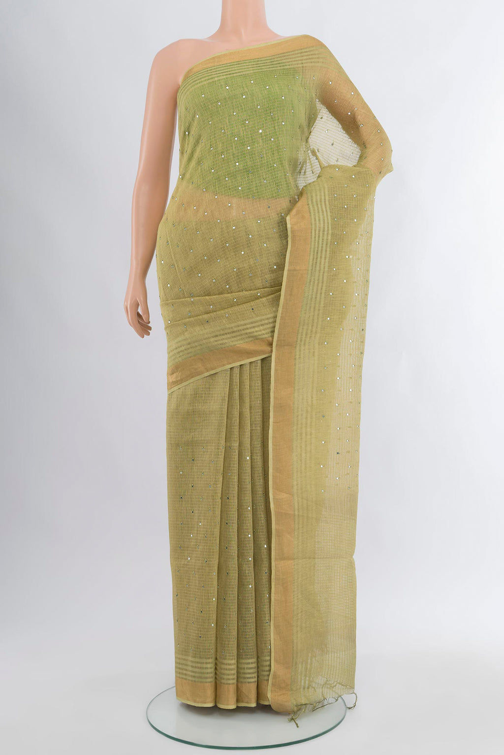 Light Green Tussar Silk Saree with Embroidery on the body and Zari Border.  displayed on a mannequin
