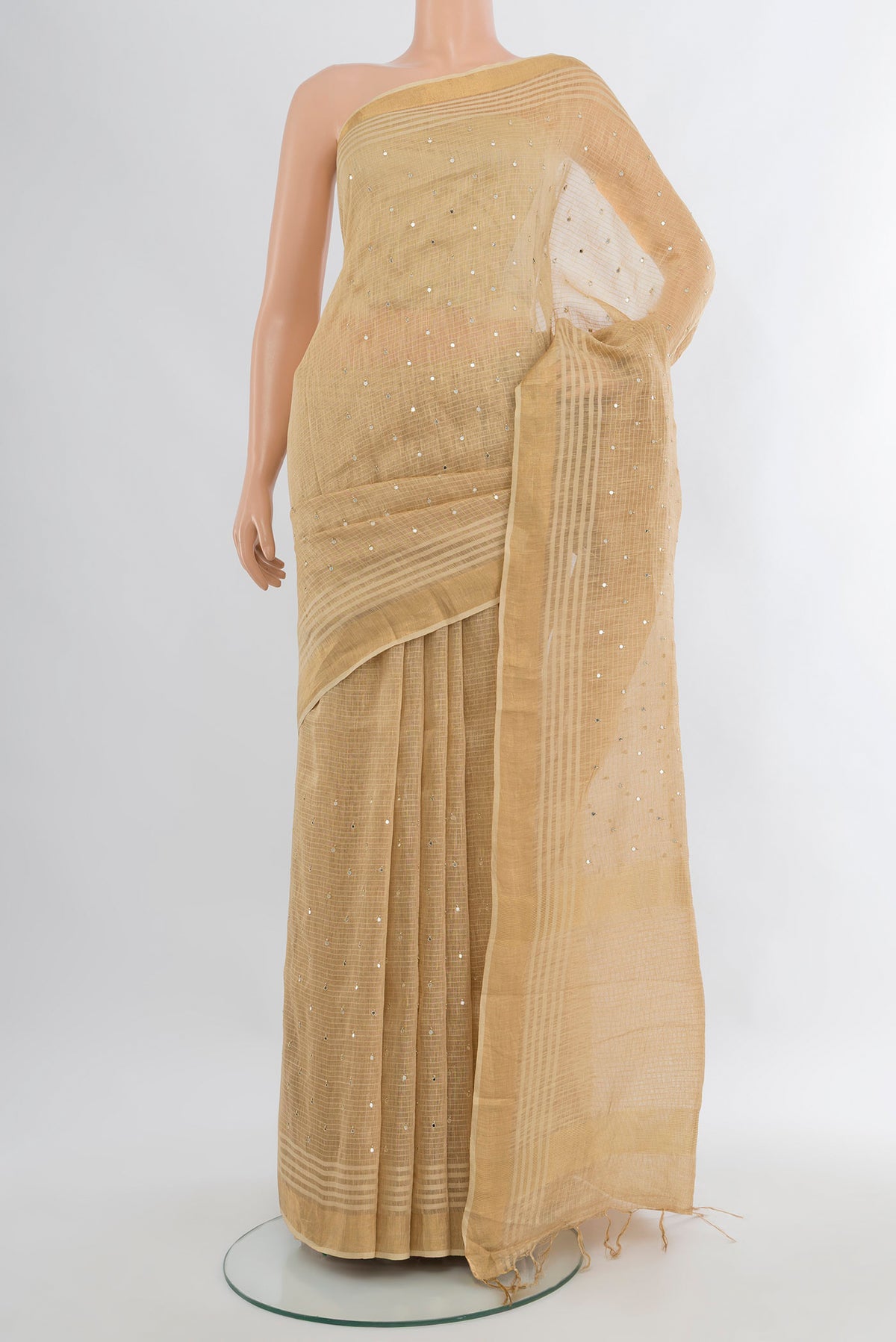 Sandal Tussar Silk Saree with Embroidery on the body and Zari Border.  displayed on a mannequin