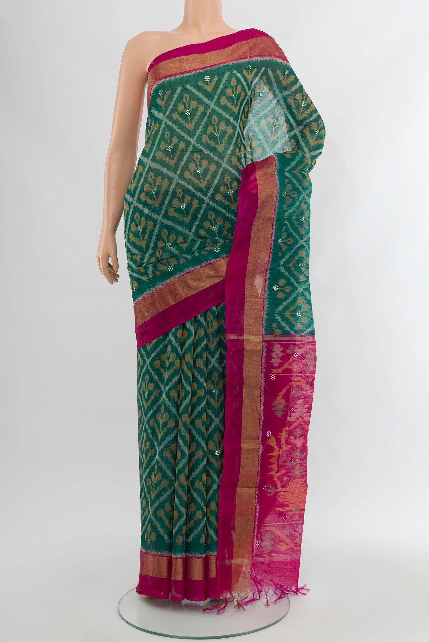 Green Silk Cotton Saree with Ikat Print on the body and Plain Border.  displayed on a mannequin