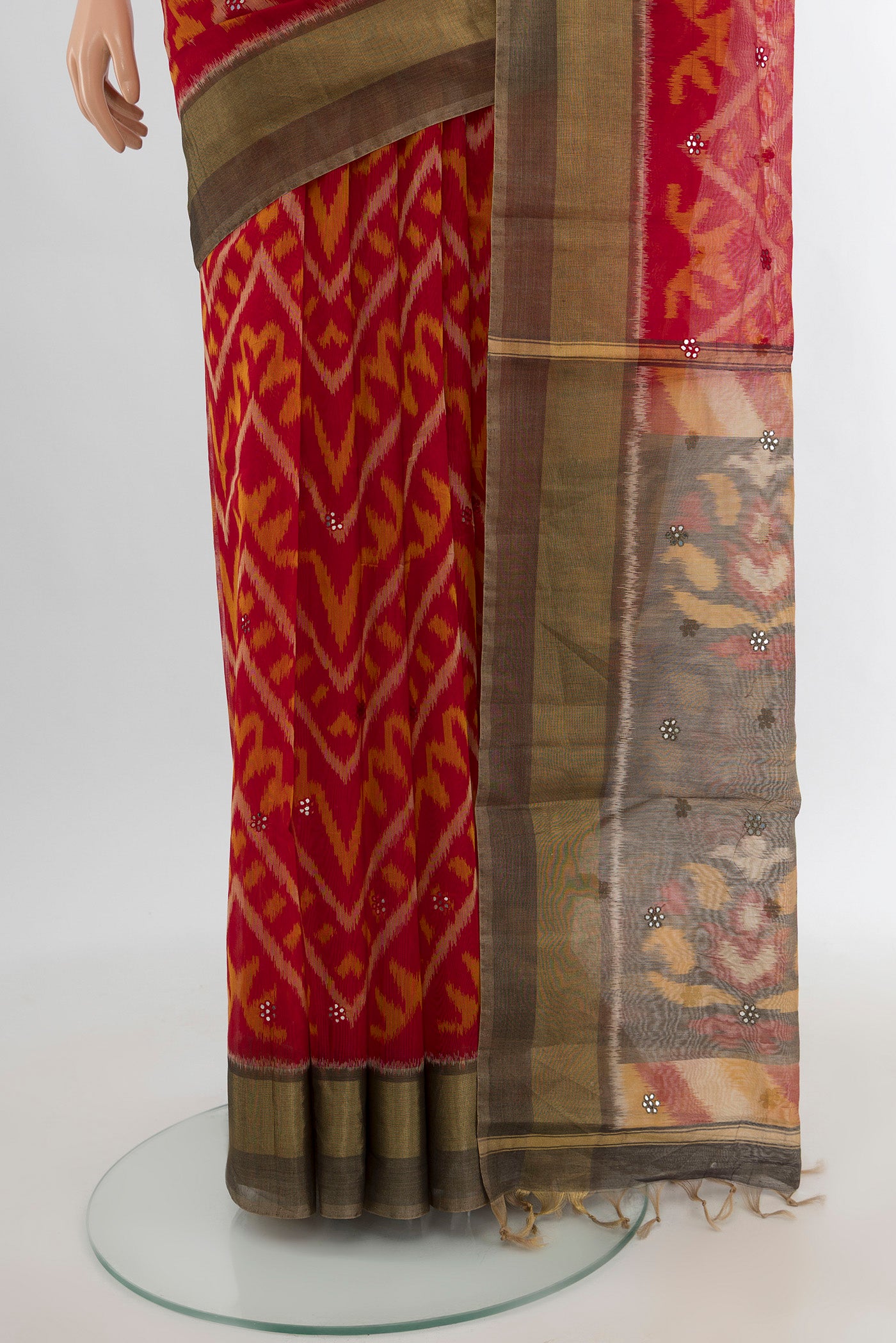 Pleats and pallu of Red Silk Cotton Saree with Ikat design on the body and Zari Border. 