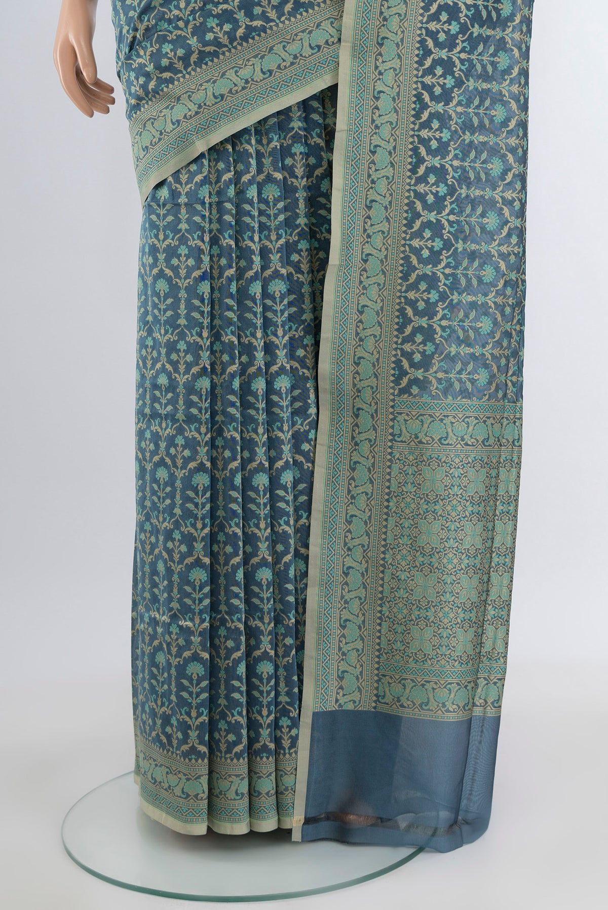 Pleats and pallu of Davys Grey Banarasi Silk Saree with Zari And Thread Butta on the body and Zari Border. 