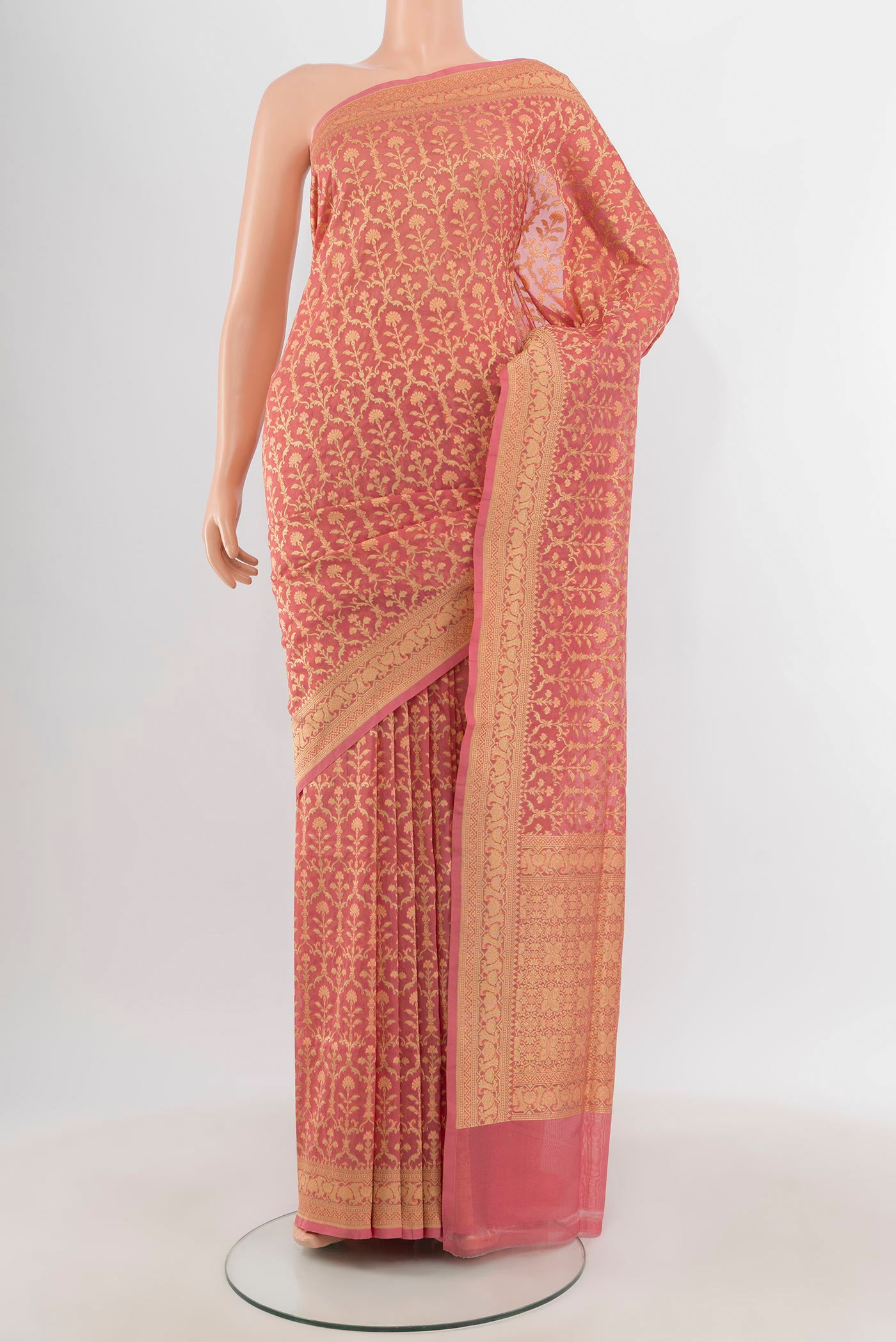 Peach Banarasi Silk Saree with Zari And Thread Butta on the body and Zari Border.  displayed on a mannequin
