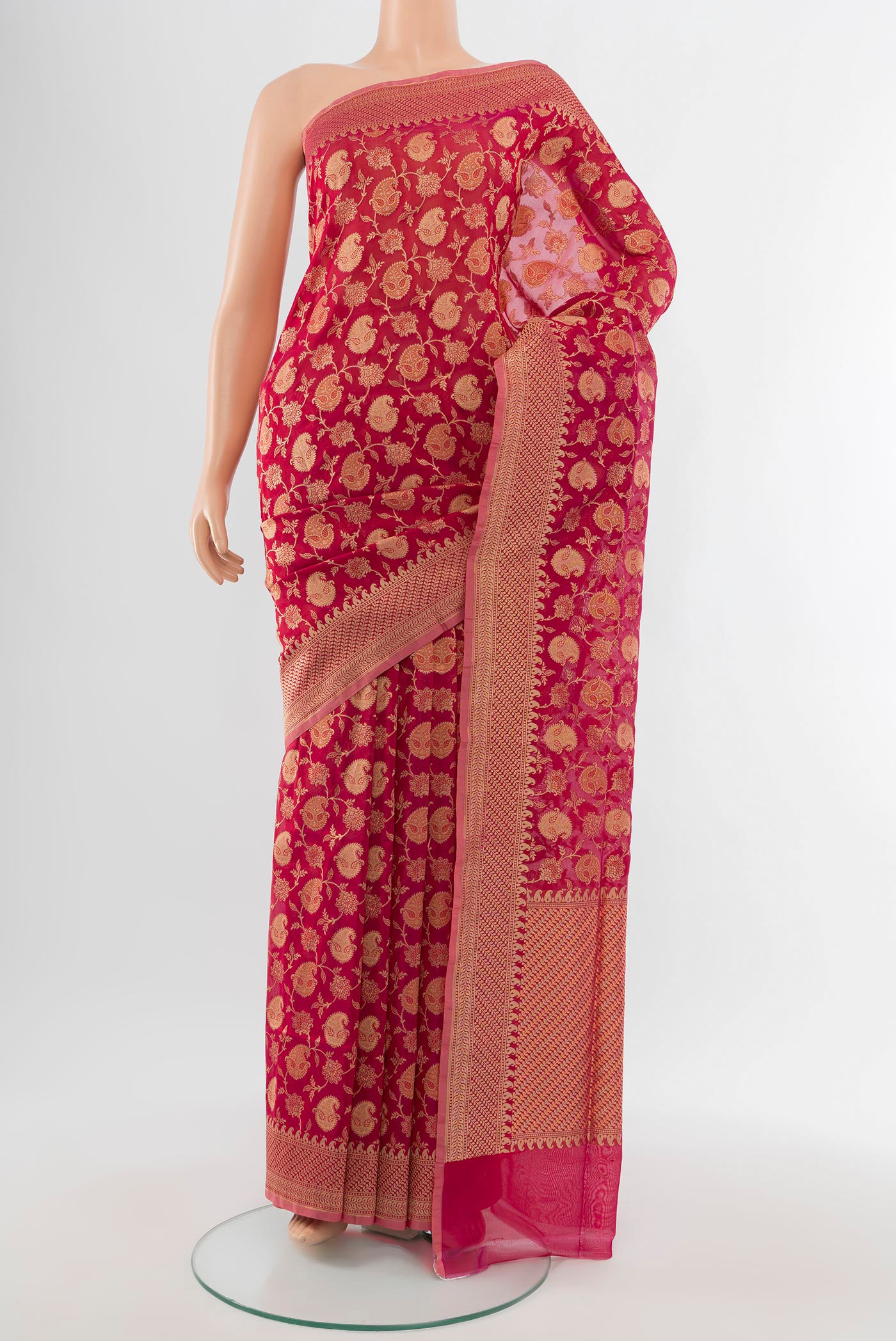 Peach Banarasi Silk Saree with Zari Butta on the body and Silk Border.  displayed on a mannequin
