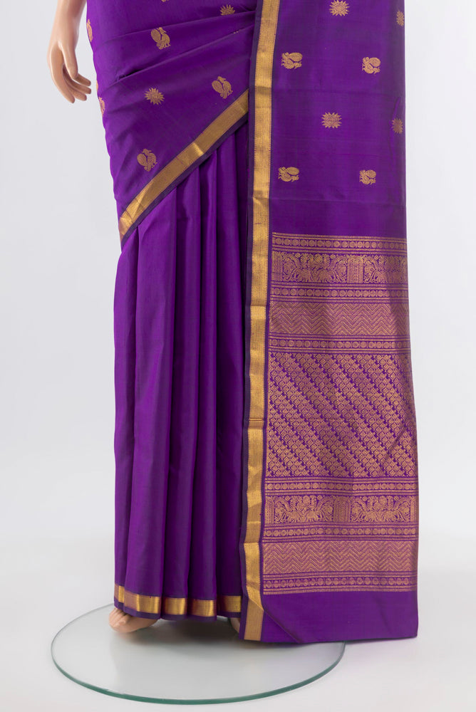Pleats and pallu of Violet Kanjivaram Silk Saree with Zari Butta on the body and Silk Border. 