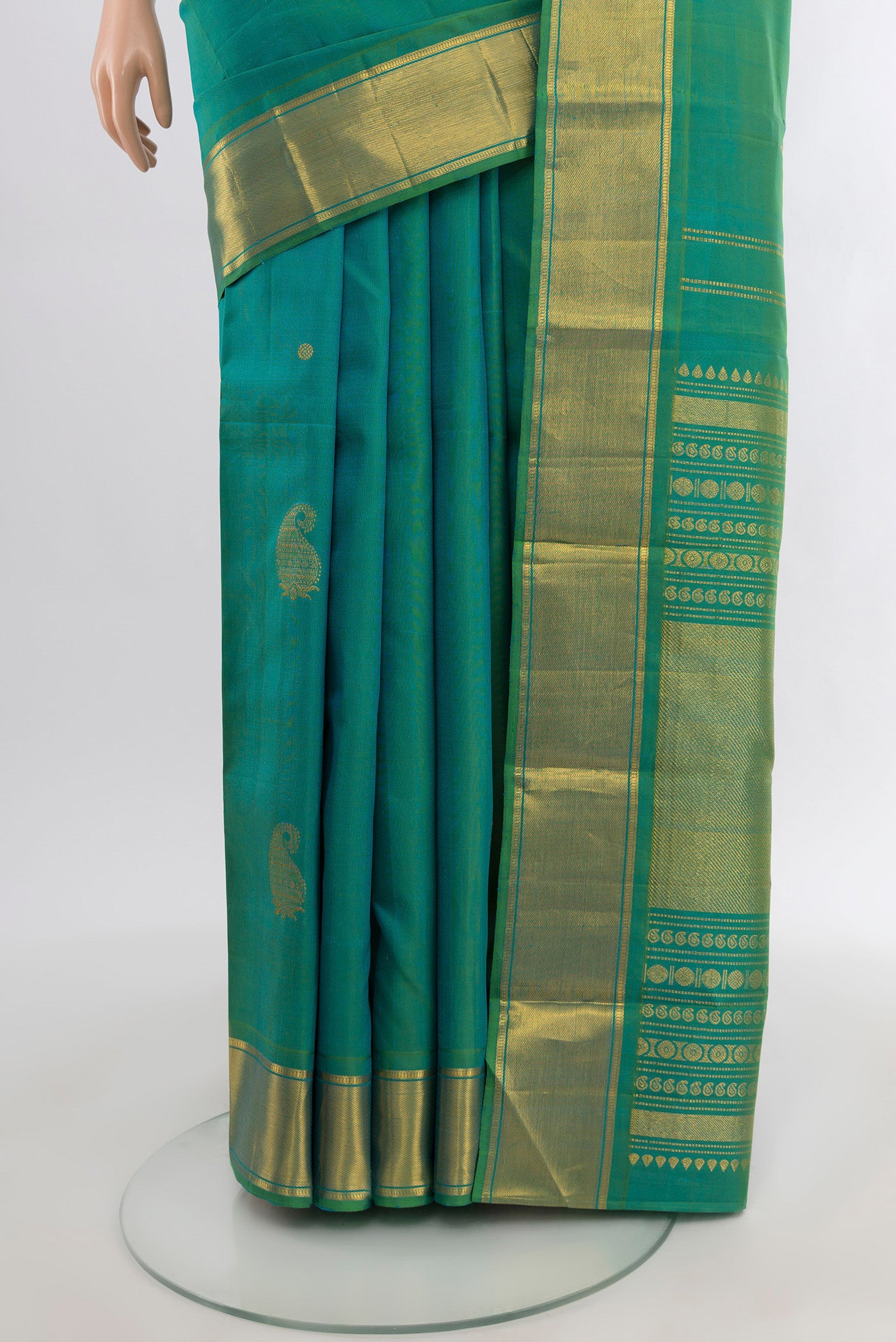 Pleats and pallu of Blue with Green Color Kanjivaram Silk Saree with Zari Butta on the body and Zari Border. 