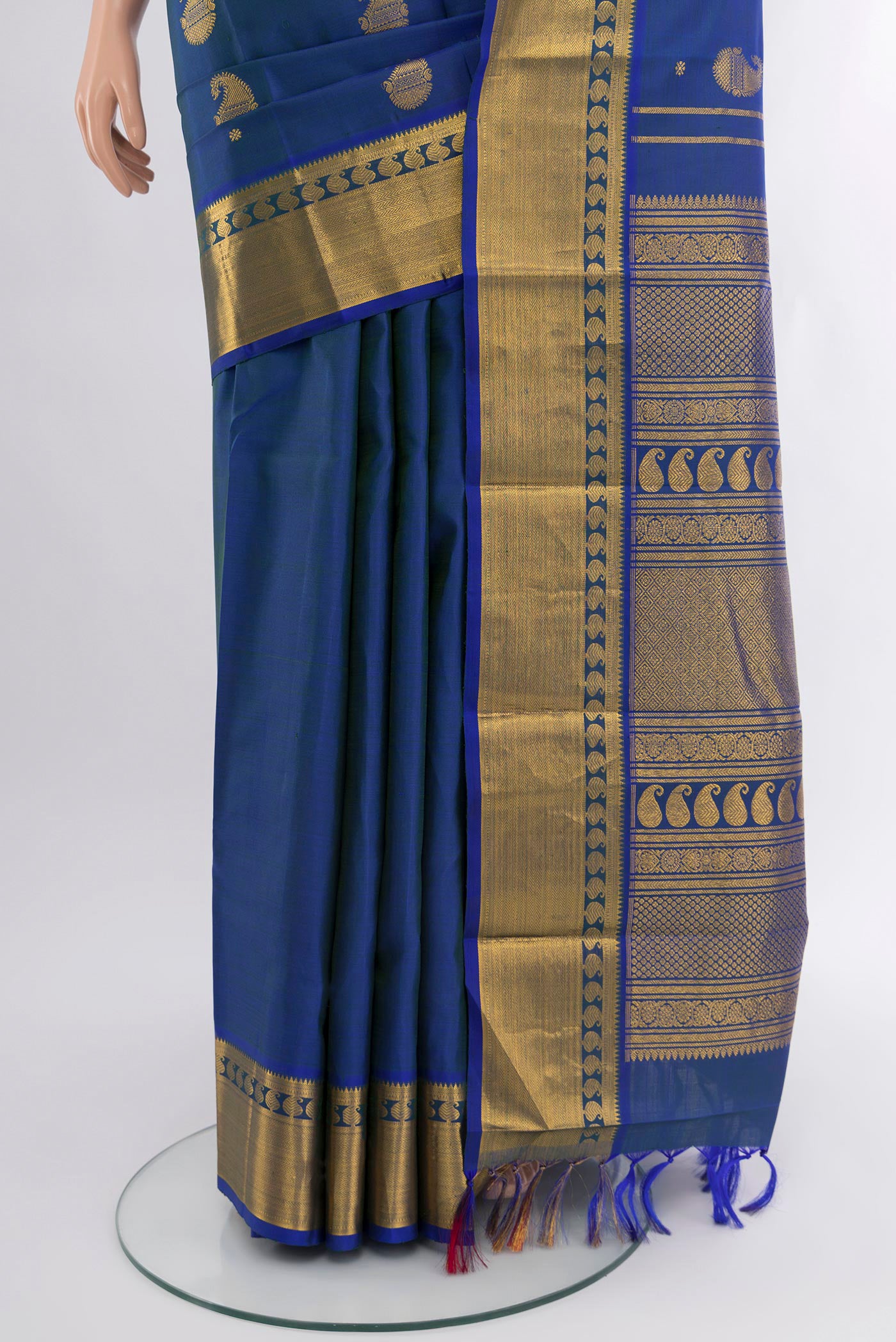 Pleats and pallu of Peacock Blue Kanjivaram Silk Saree with Zari Butta on the body and Zari Border. 