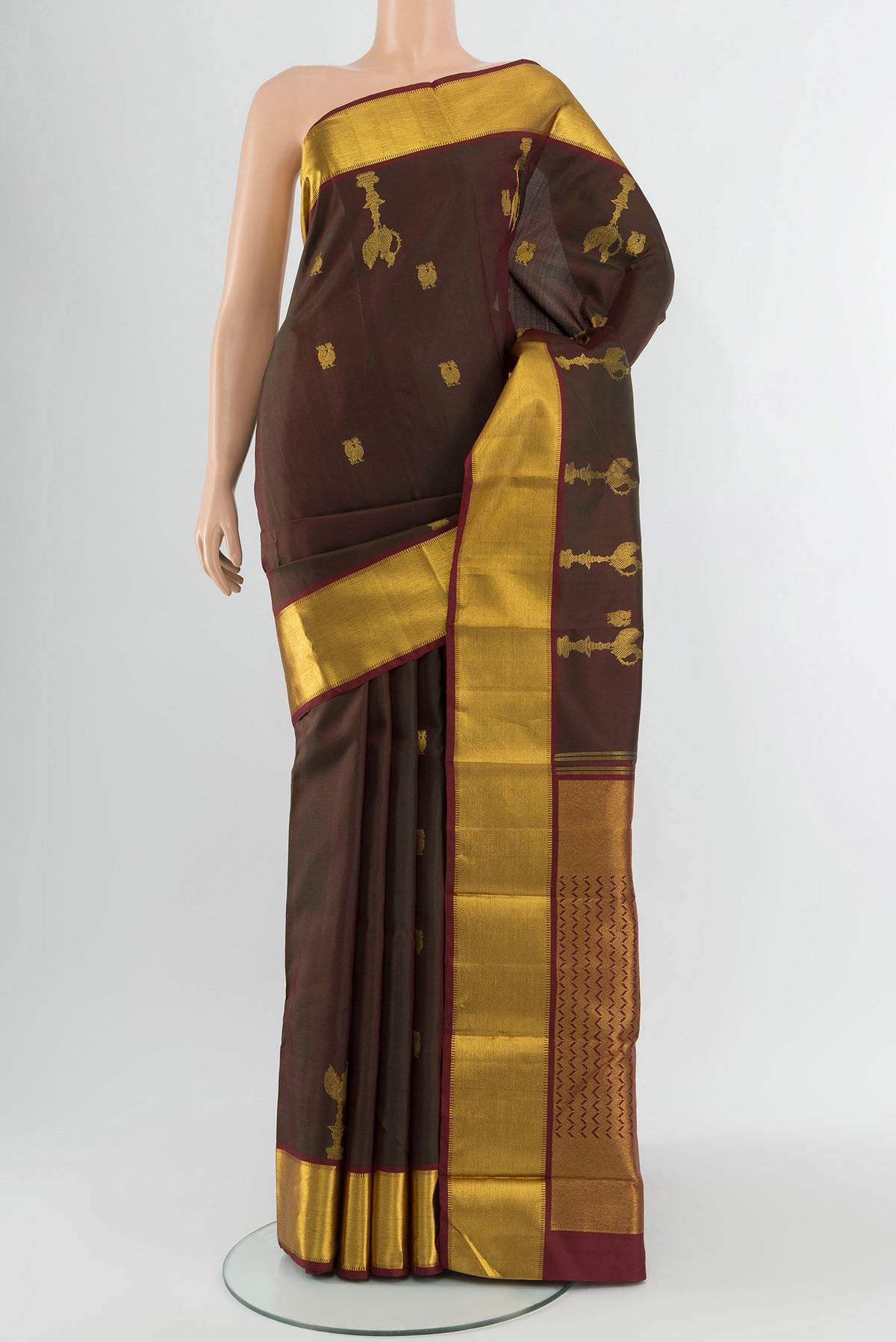 Multi Color Kanjivaram Silk Saree with Zari Butta on the body and Zari Border.  displayed on a mannequin