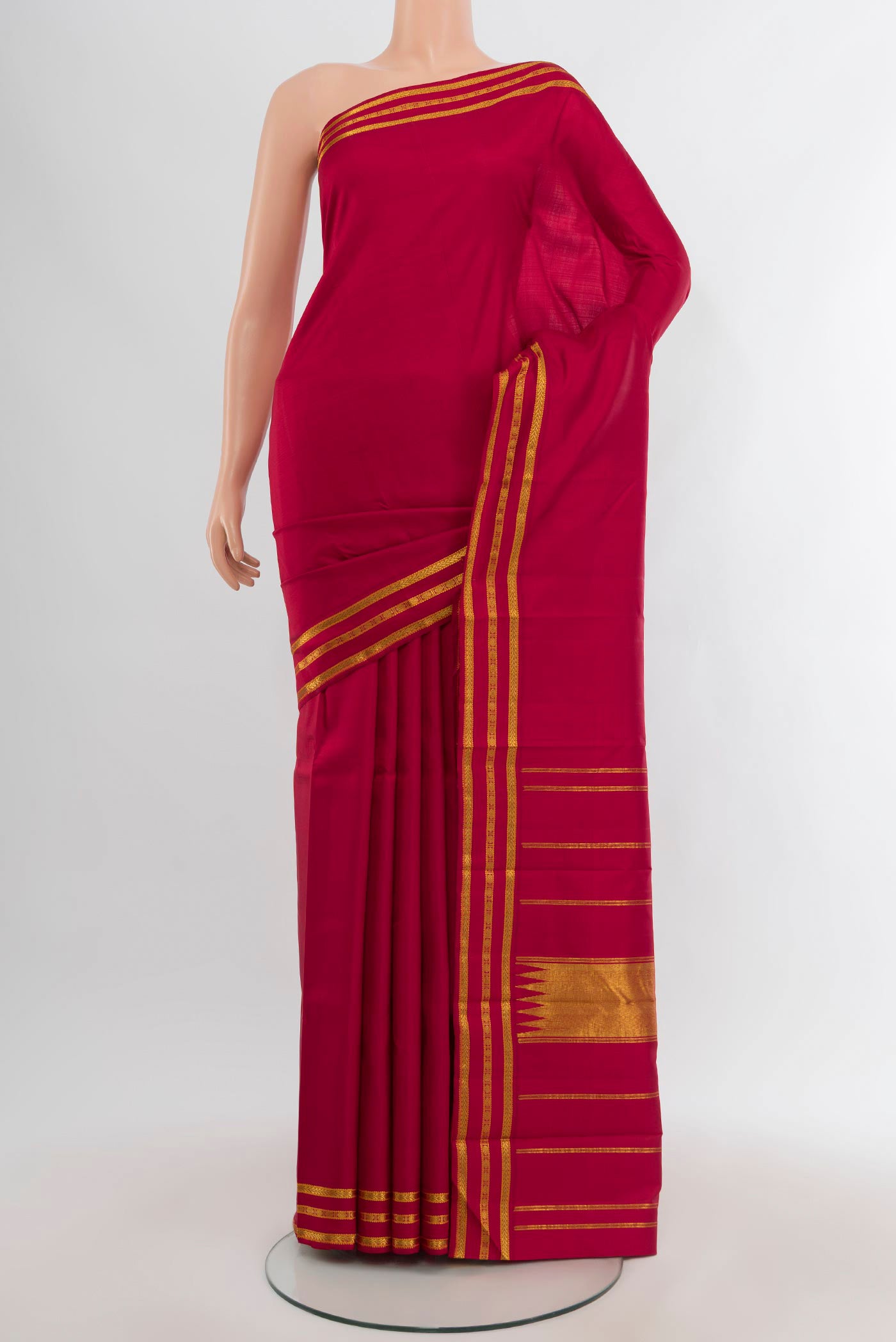 Maroon Kanchipuram Silk Saree with Plain Body and Zari Border.  displayed on a mannequin