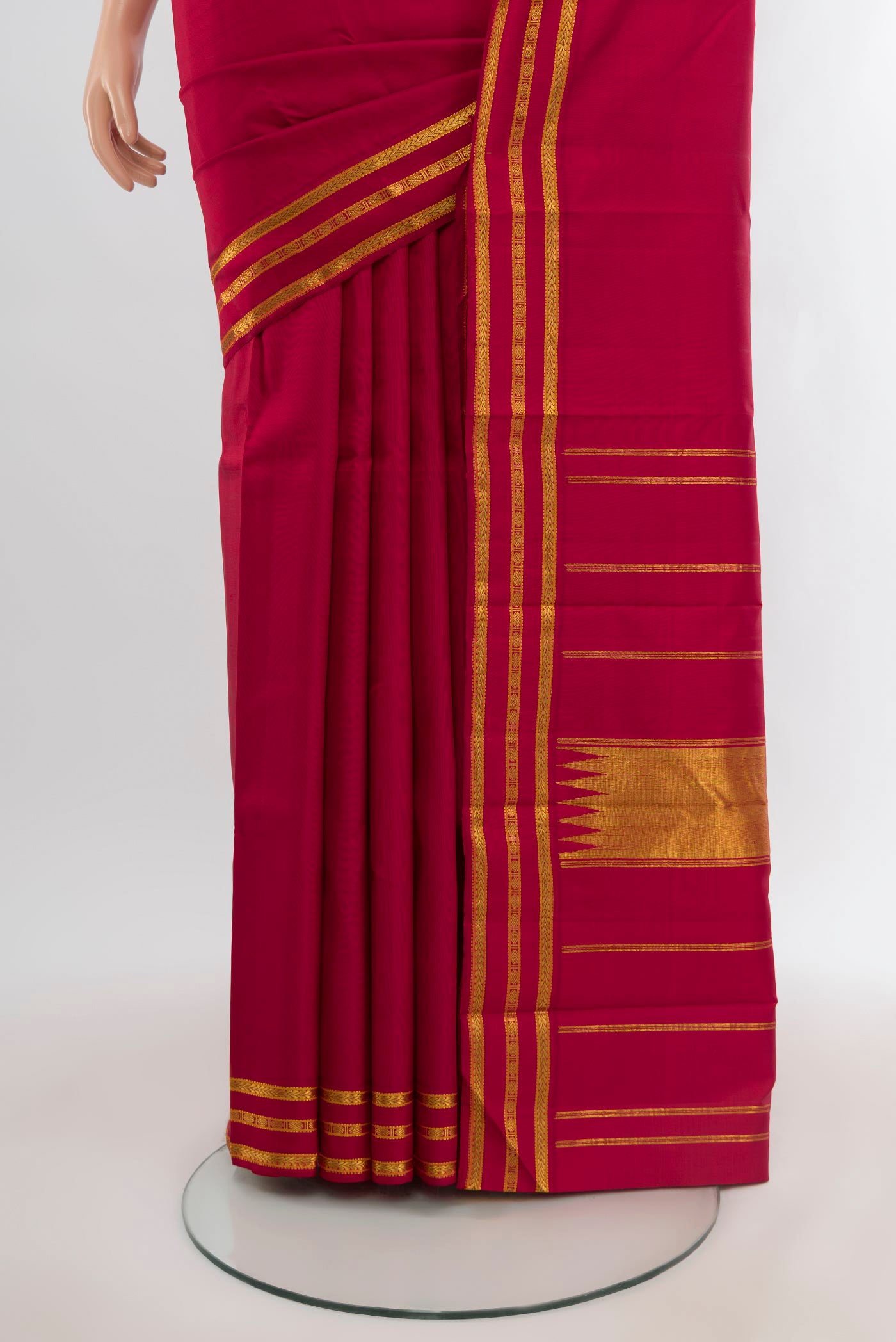 Pleats and pallu of Maroon Kanchipuram Silk Saree with Plain Body and Zari Border. 