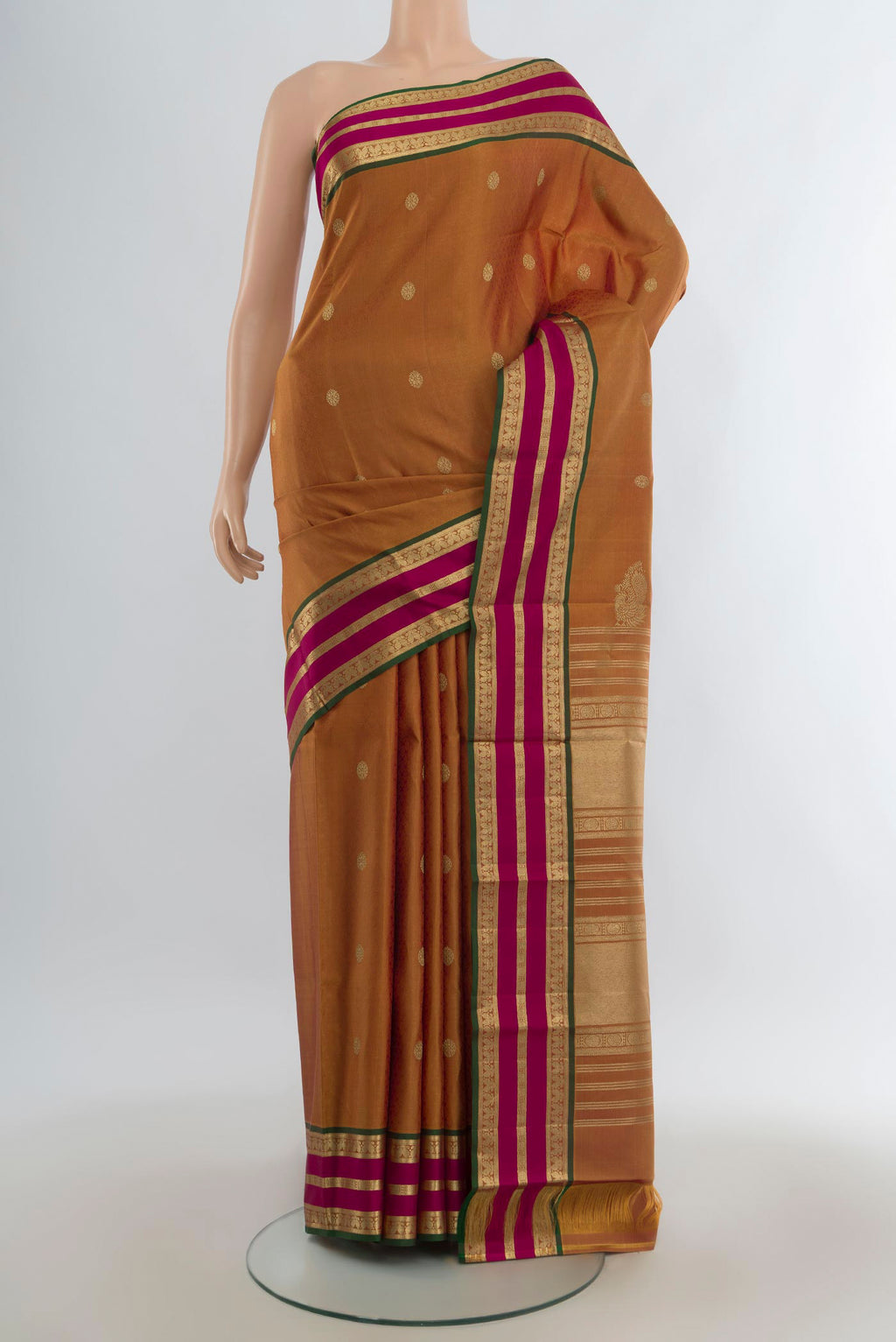 Pure Silk Mustard Kanjivaram Saree with Zari Butta on the body and Zari Border.  displayed on a mannequin