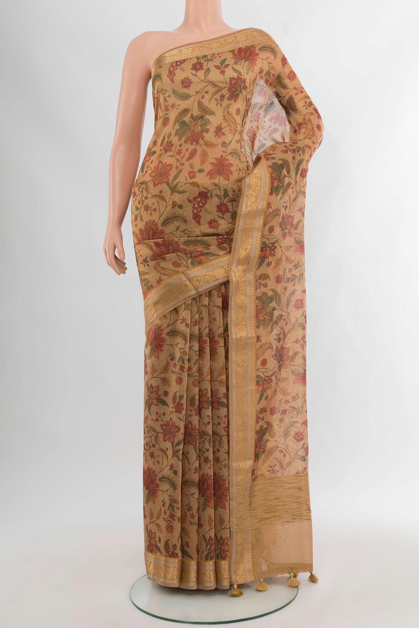 Brown Cotton Saree with Floral Print on the body and Zari Border.  displayed on a mannequin