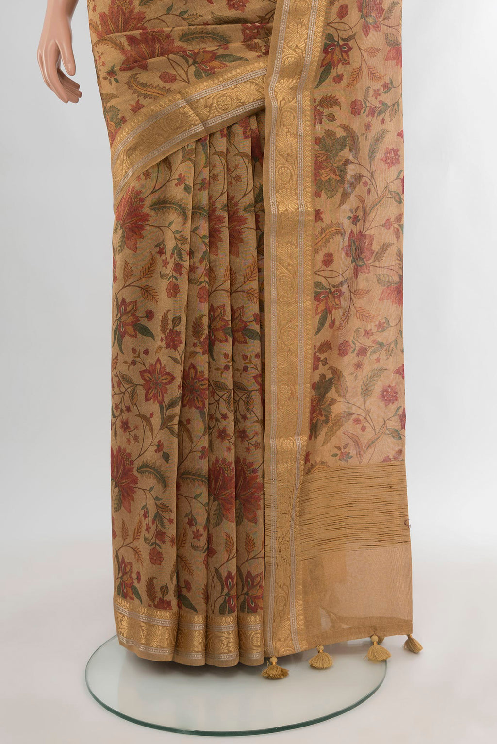 Pleats and pallu of Brown Cotton Saree with Floral Print on the body and Zari Border. 