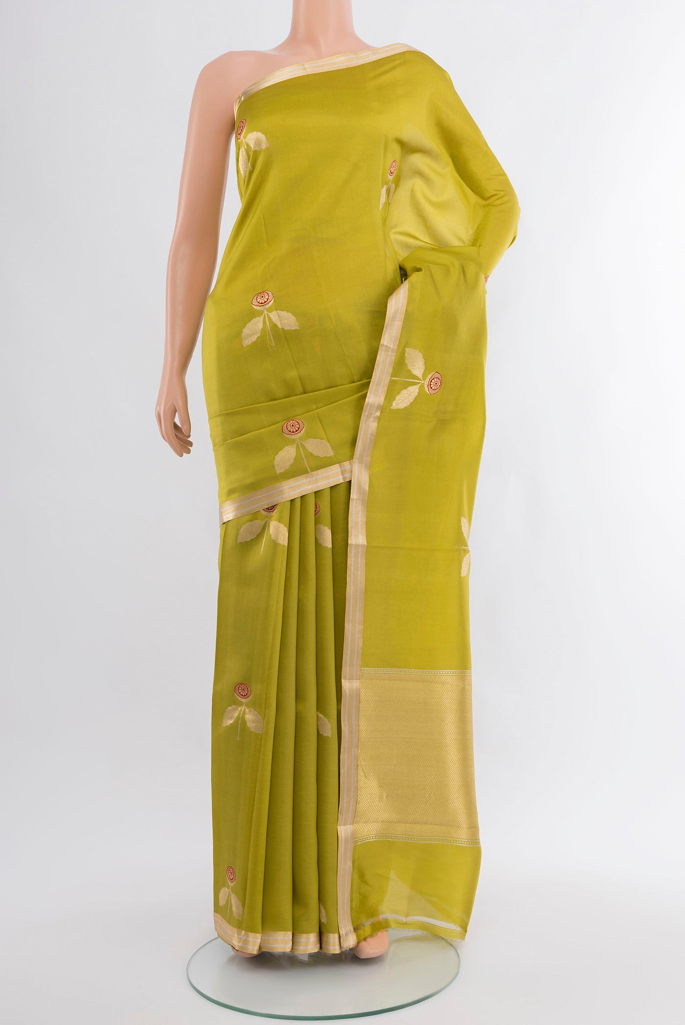 Green Banarasi Katan Silk Saree with Zari Butta on the body and Zari Border.  displayed on a mannequin