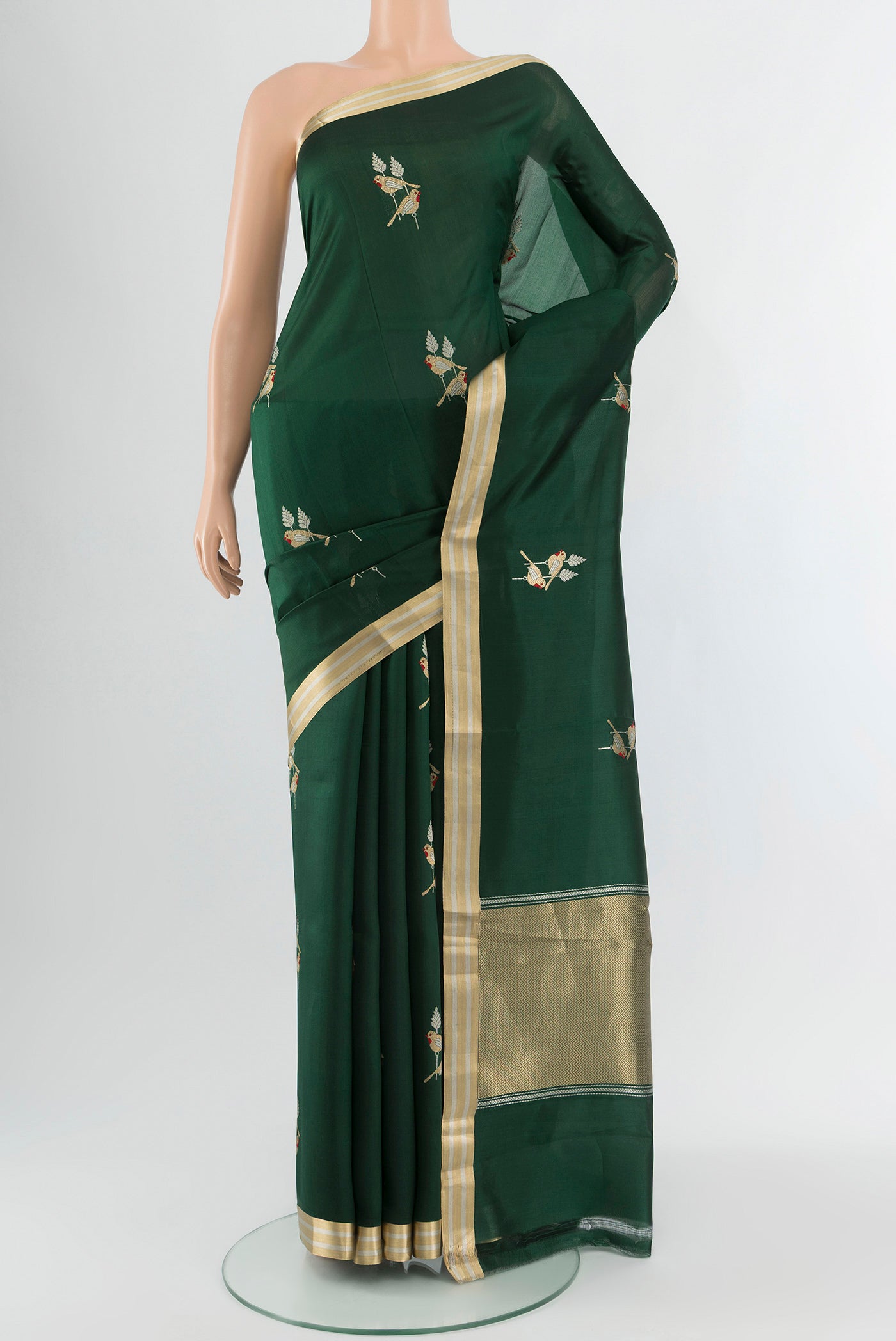 Bottle Green Banarasi Silk Saree with Zari Butta on the body and Zari Border.  displayed on a mannequin