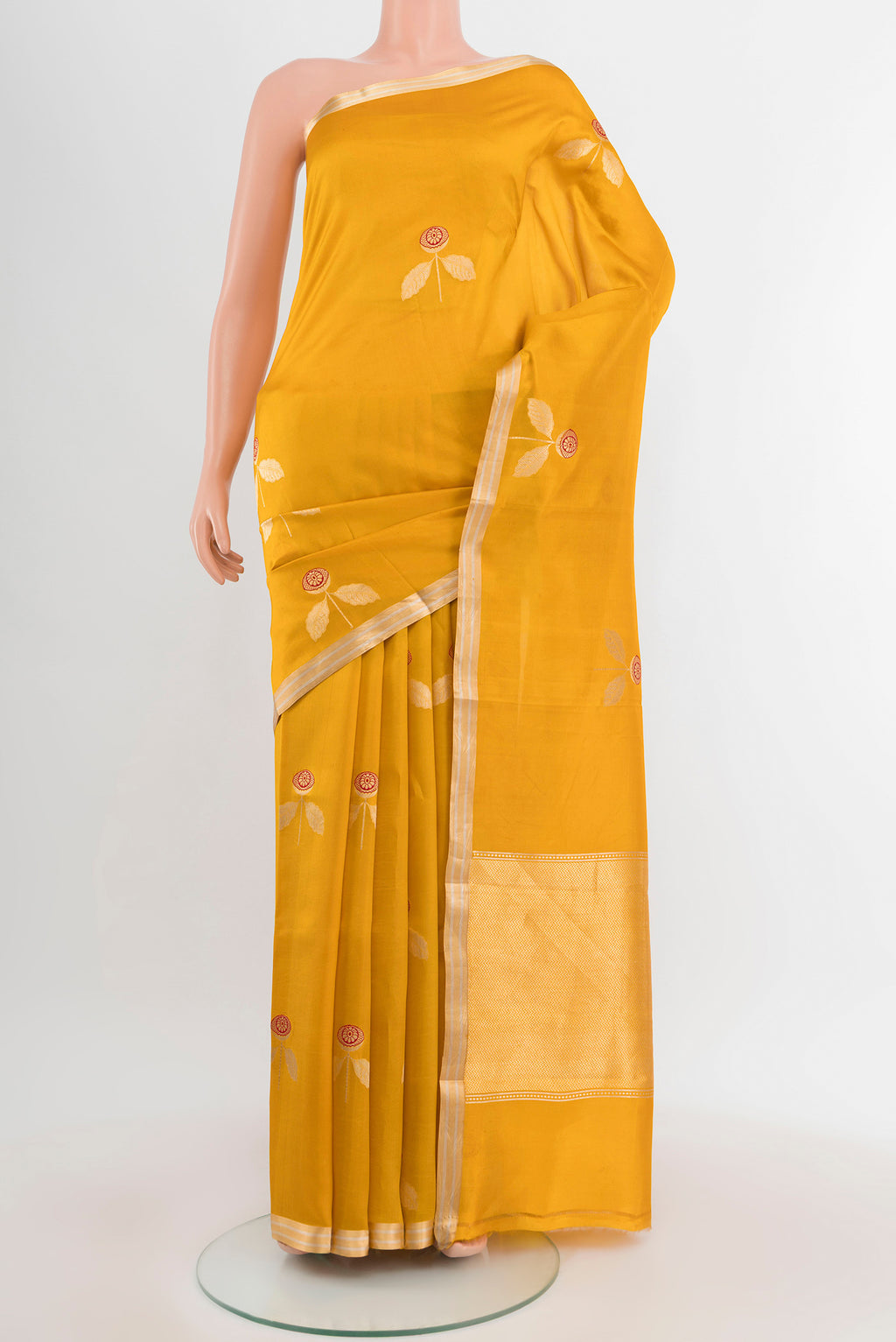 Mustard Banarasi Katan Silk Saree with Zari Butta on the body and Silk Border.  displayed on a mannequin