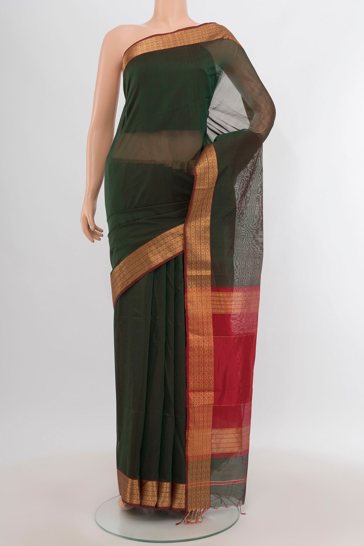 Bottle Green Maheshwari Silk Cotton Saree with Plain Body and Zari Border.  displayed on a mannequin