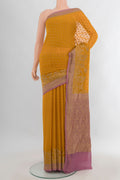 Yellow Banarasi Georgette Saree with Zari Butta on the body and Zari Border.  displayed on a mannequin