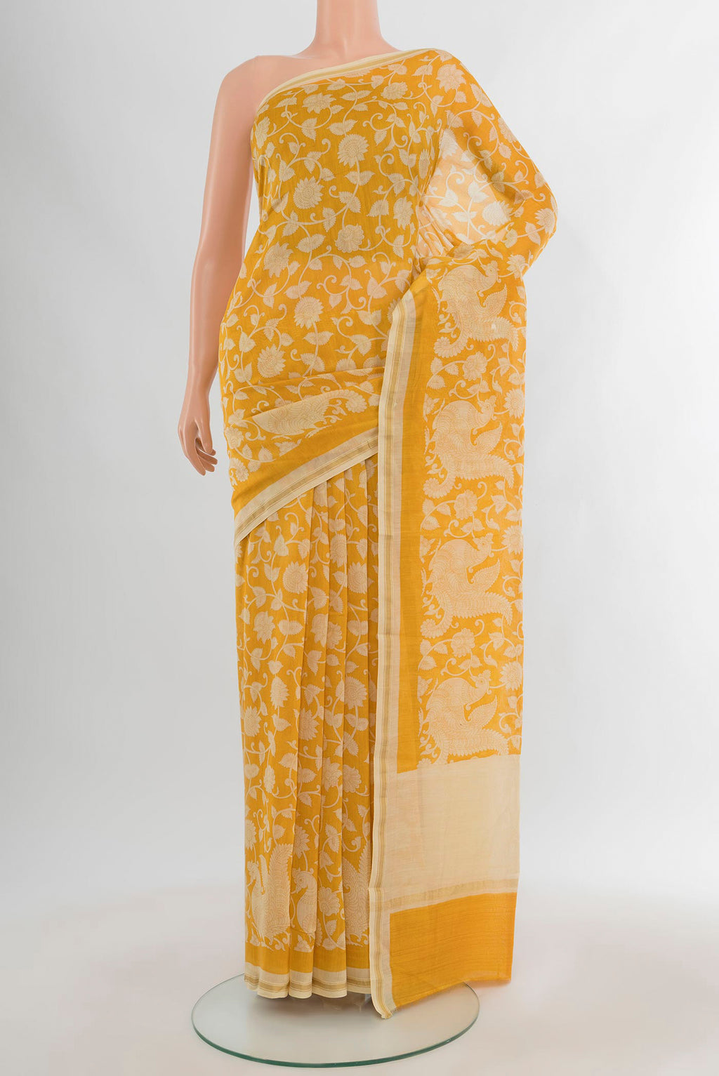Yellow Maheshwari Silk Cotton Saree with Floral Print on the body and Zari Border.  displayed on a mannequin