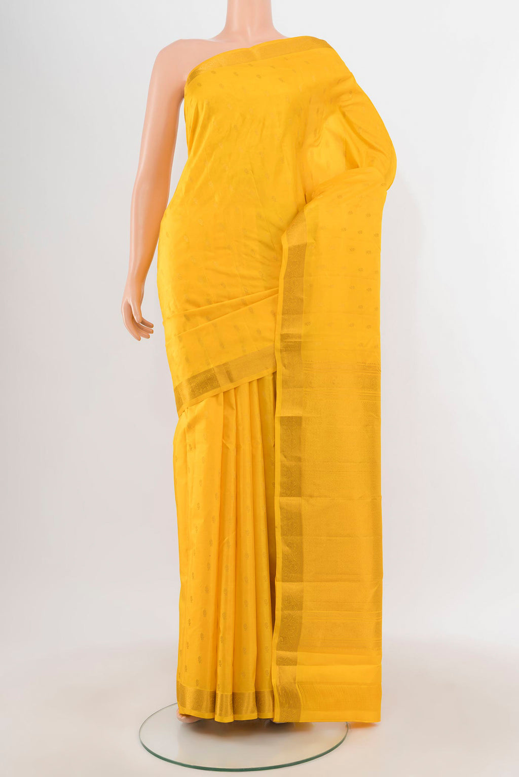 Yellow Kanchipuram Silk Saree with Zari Butta on the body and Zari Border.  displayed on a mannequin