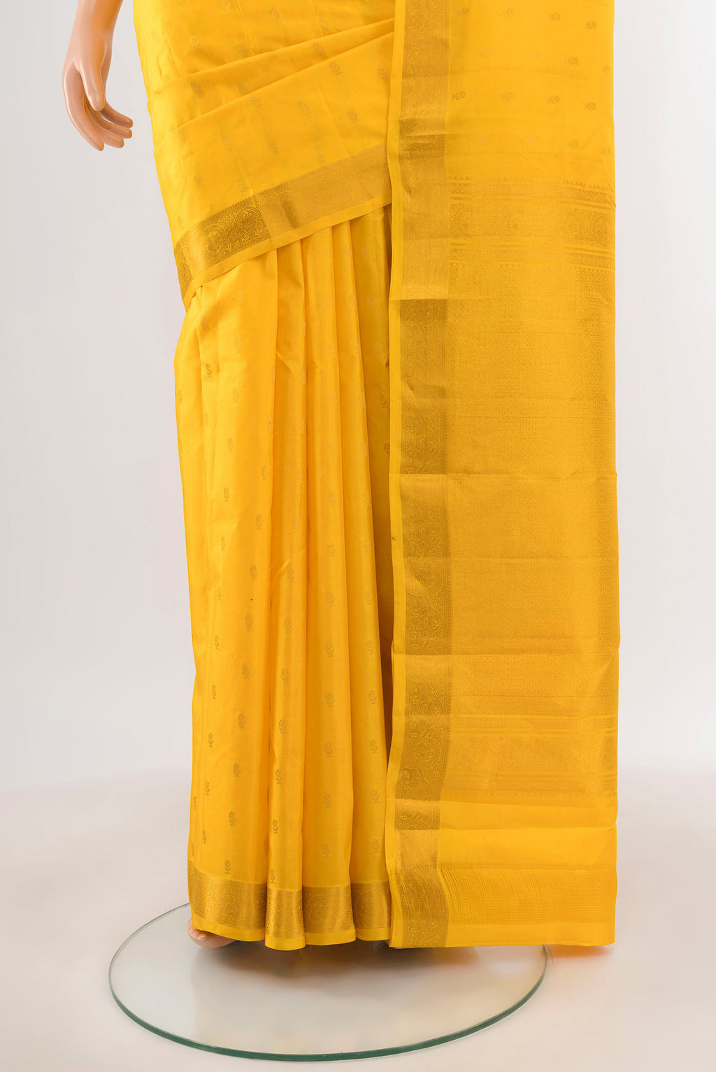 Pleats and pallu of Yellow Kanchipuram Silk Saree with Zari Butta on the body and Zari Border. 