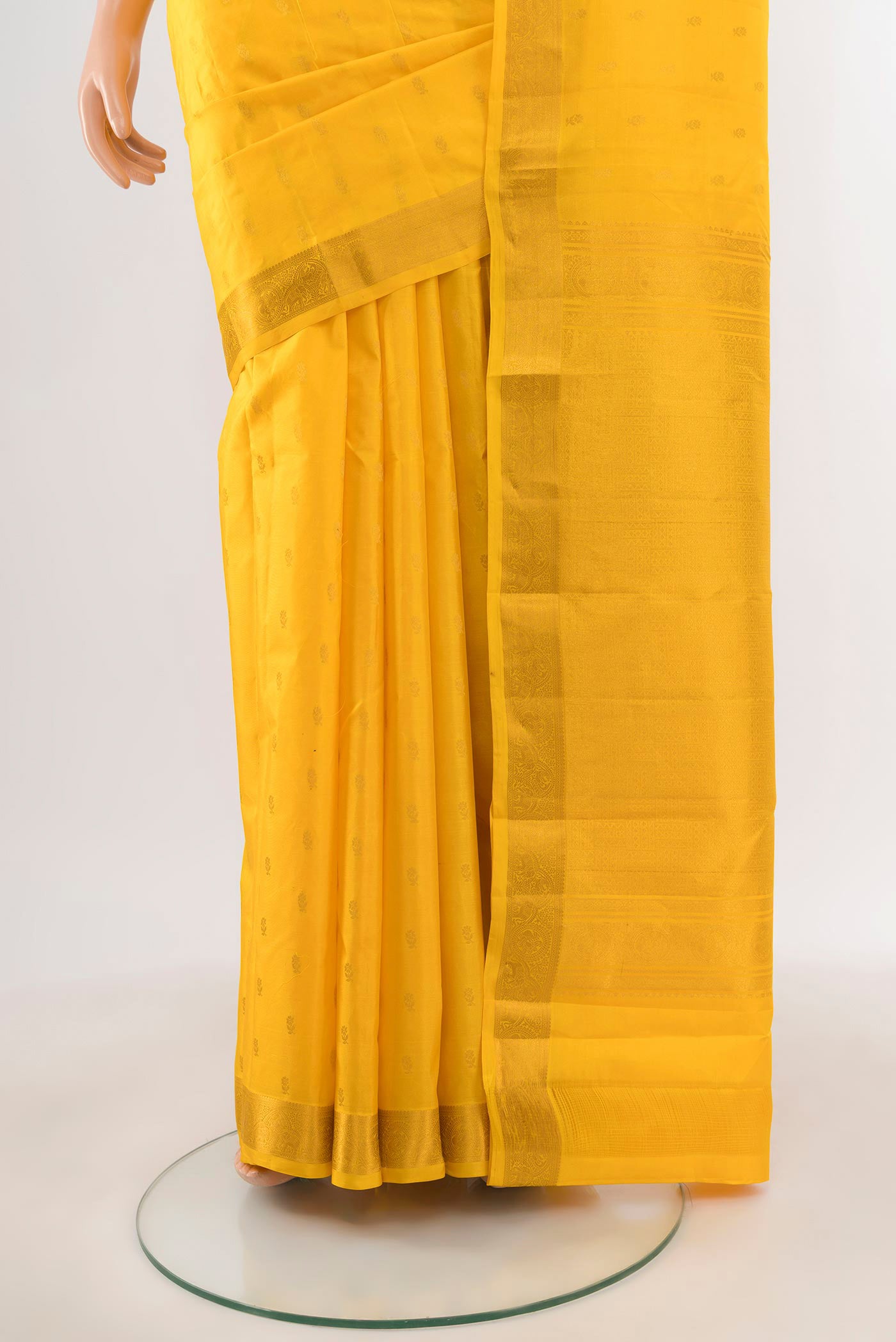 Pleats and pallu of Yellow Kanchipuram Silk Saree with Zari Butta on the body and Zari Border. 