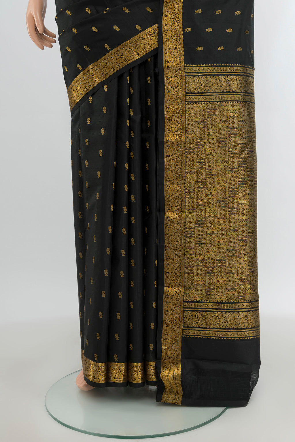 Pleats and pallu of Black Kanchipuram Silk Saree with Zari Butta on the body and Zari Border. 