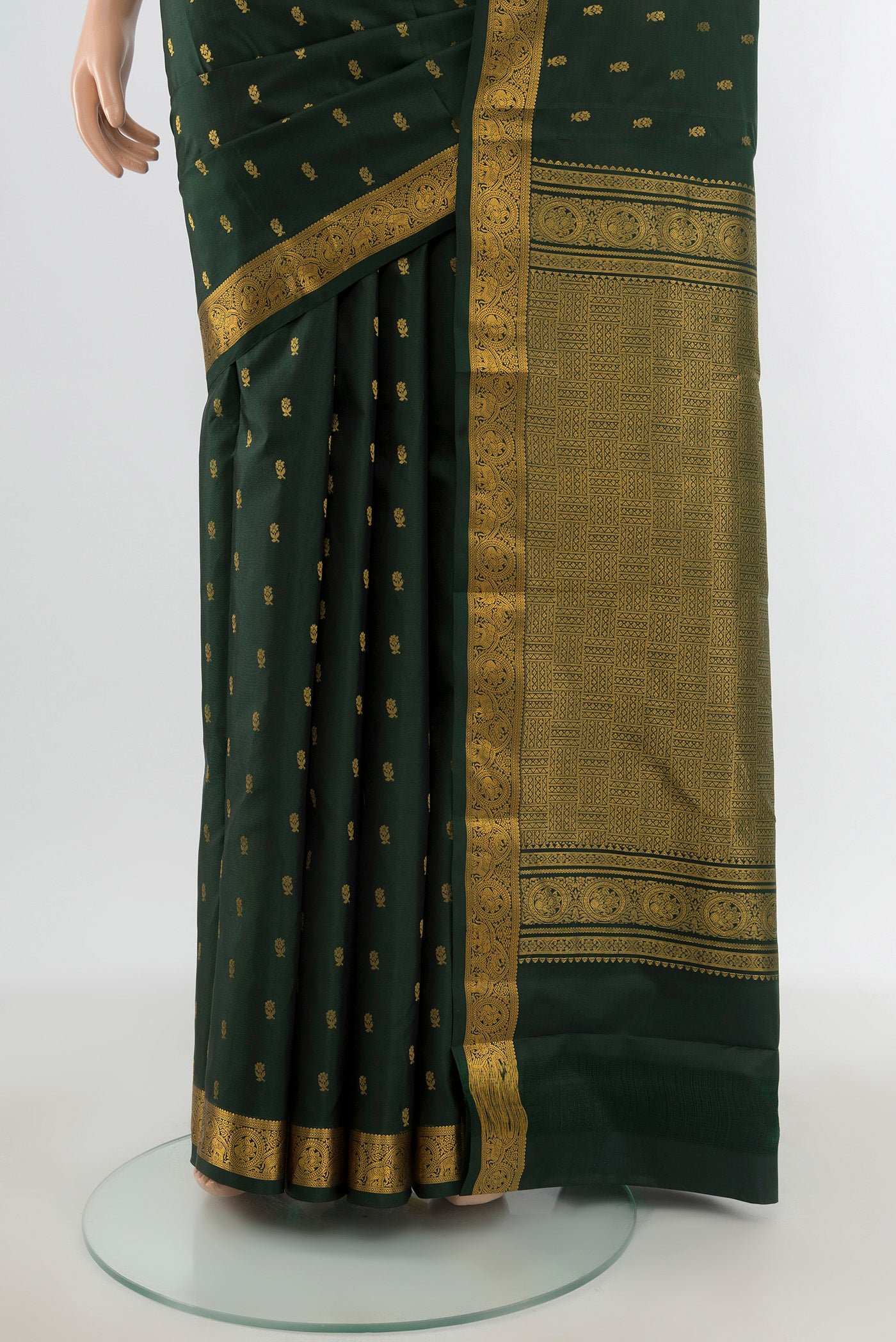 Pleats and pallu of Bottle Green Kanchipuram Silk Saree with Zari Butta on the body and Zari Border. 