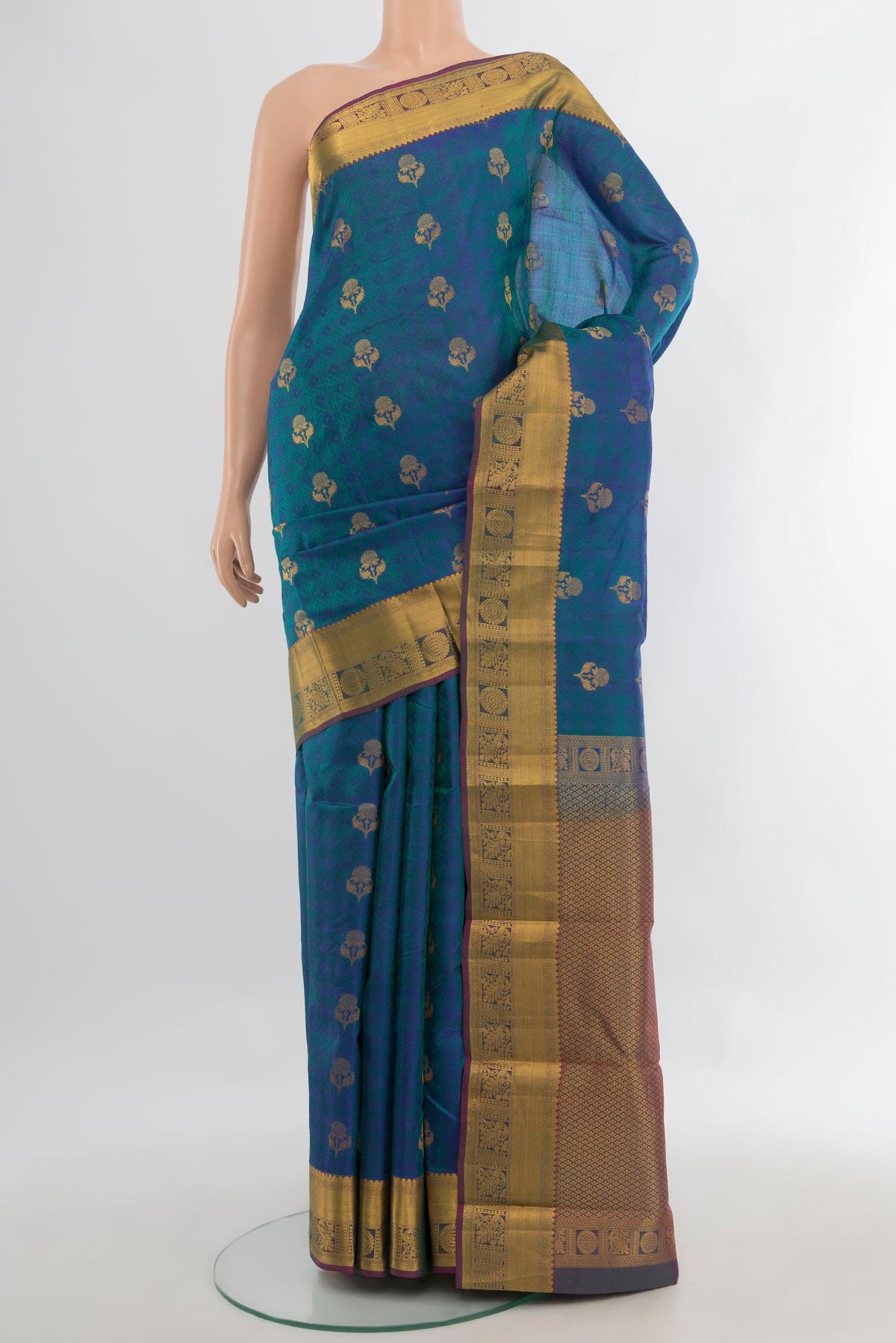 Pure Silk Peacock Blue Kanchipuram Saree with Jacquard With Zari Butta on the body and Zari Border.  displayed on a mannequin
