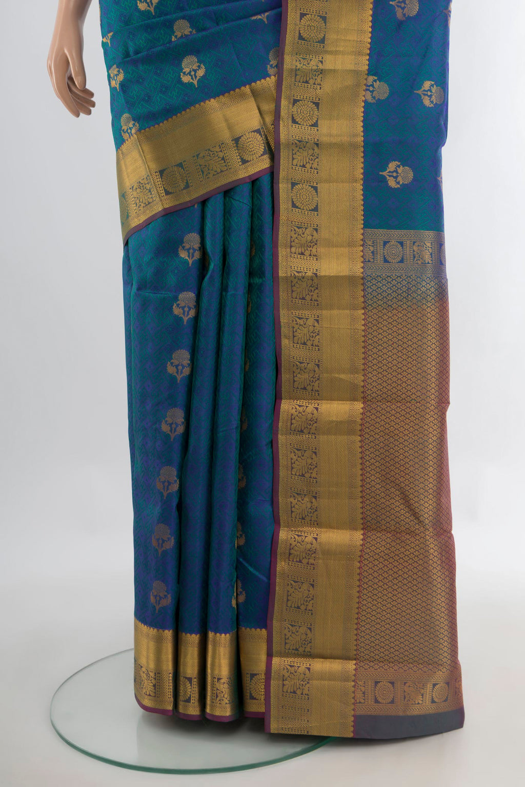 Pleats and pallu of Pure Silk Peacock Blue Kanchipuram Saree with Jacquard With Zari Butta on the body and Zari Border. 